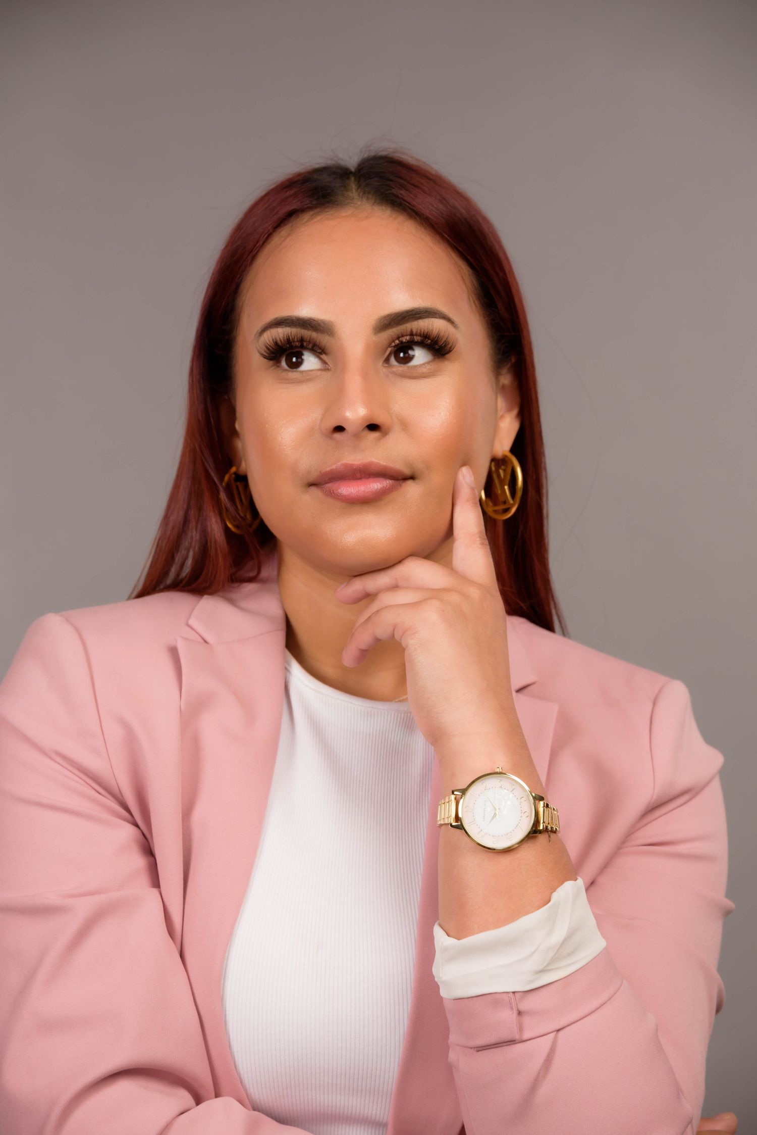 Professional headshots of person in pink blazer and white top showing various expressions.