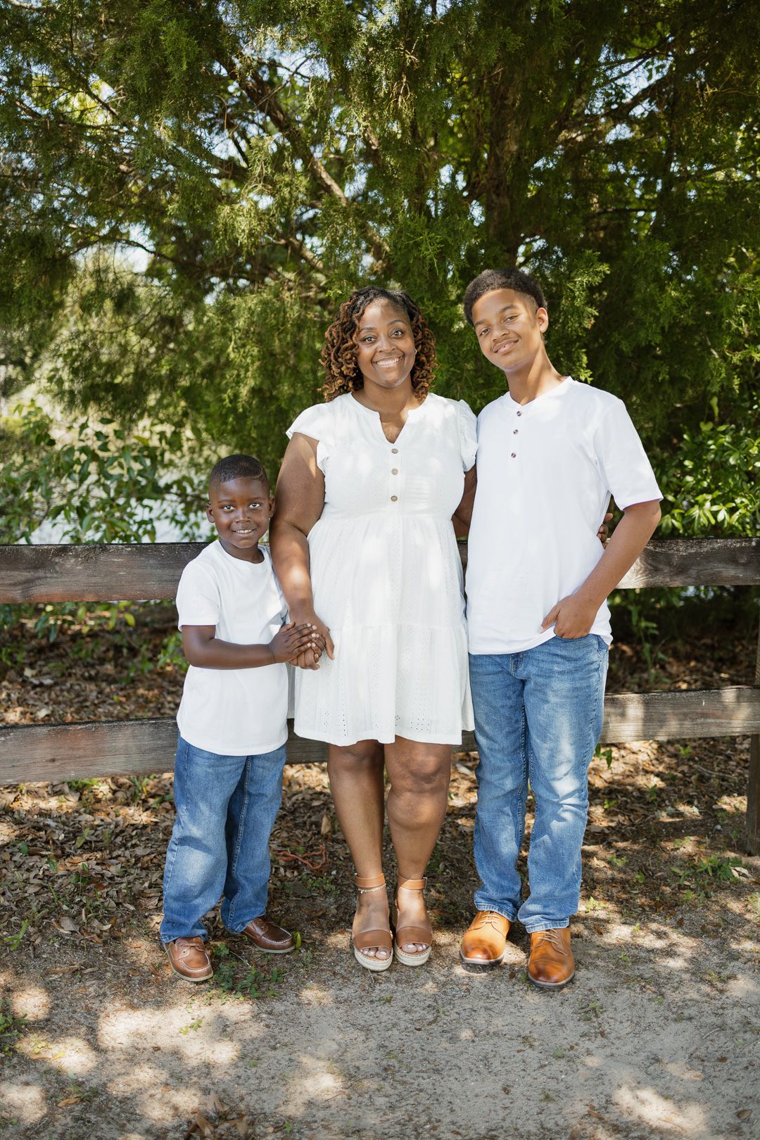 Outdoor family portraits captured in a peaceful park setting in Bagdad, Florida.