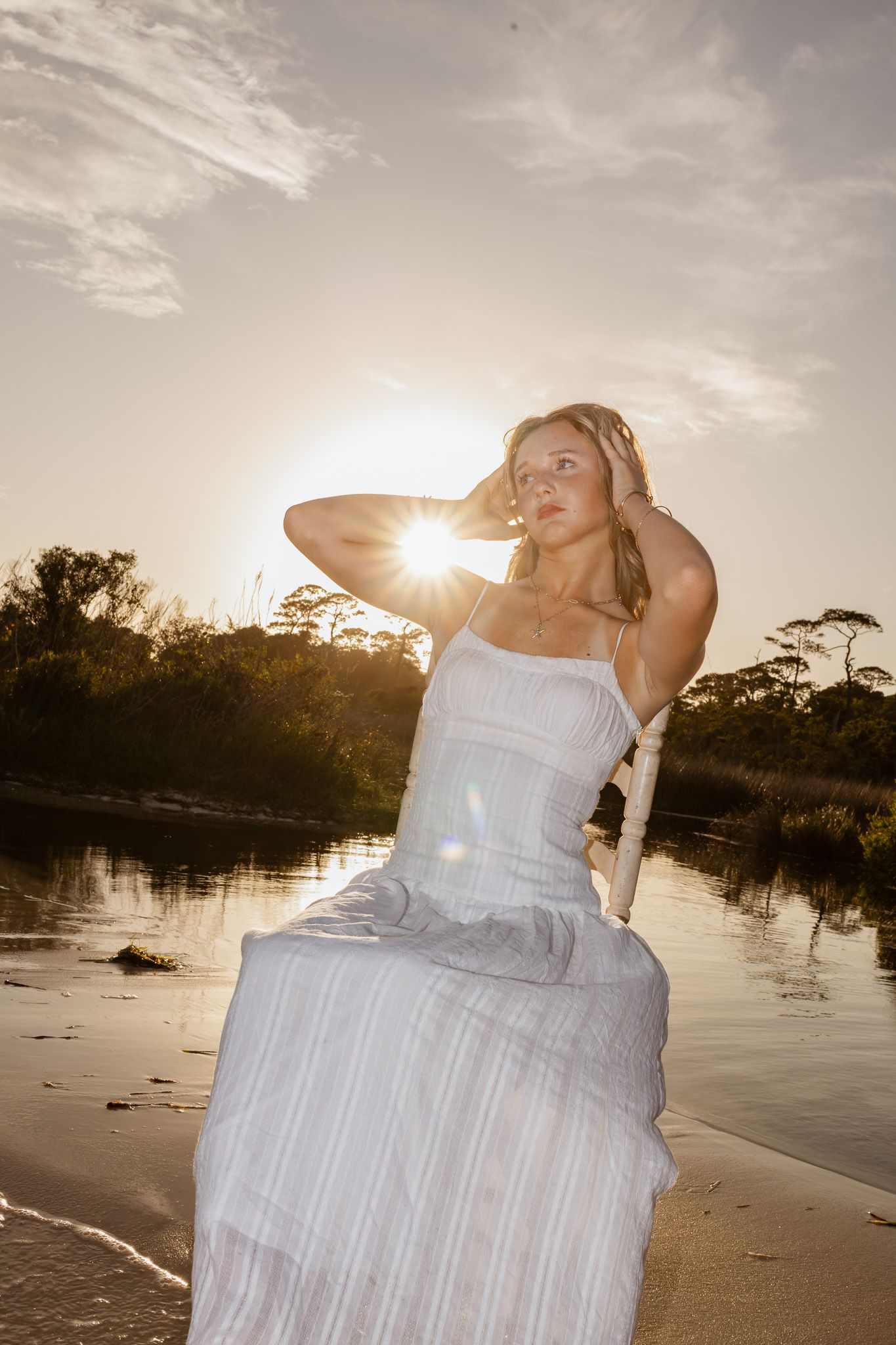 Pensacola Beach senior photography session featuring a graduate posing by the water
