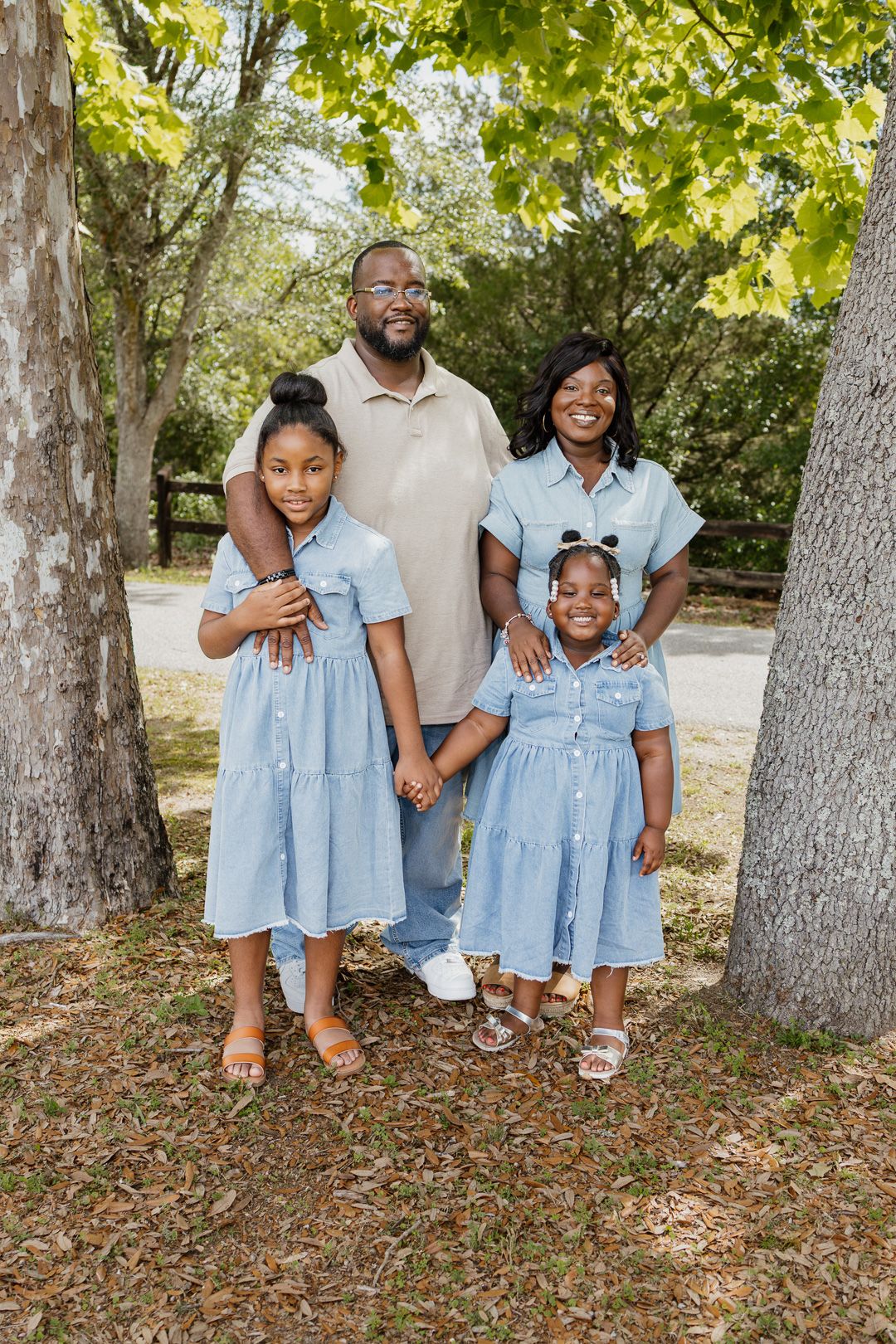 Outdoor family portraits captured in a peaceful park setting in Bagdad, Florida.