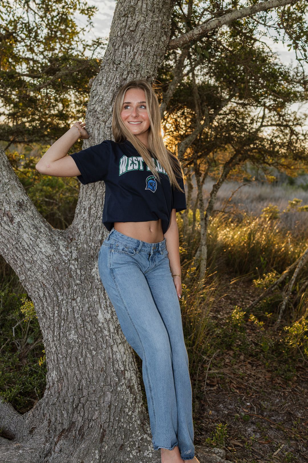 Pensacola Beach senior photography session featuring a graduate posing by the water