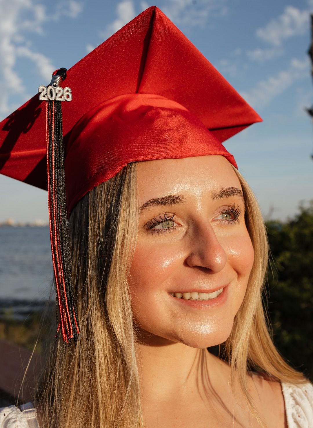 Pensacola Beach senior photography session featuring a graduate posing by the water