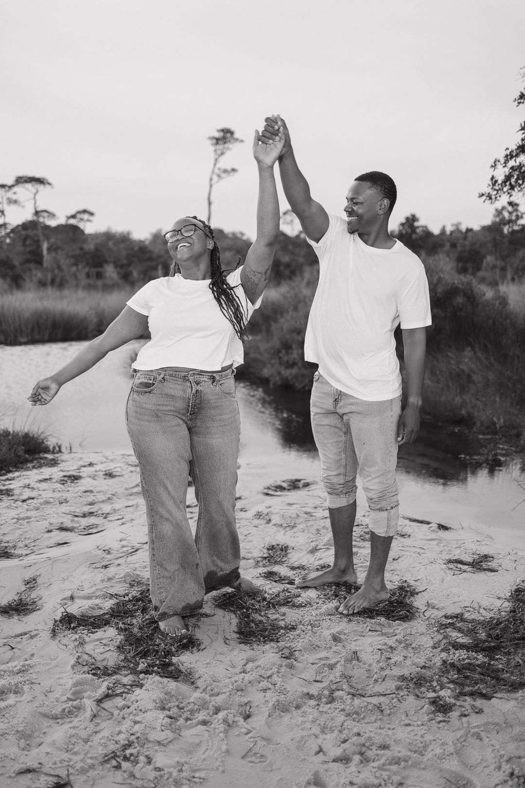 Couple embracing on Pensacola Beach during a sunset photography session.