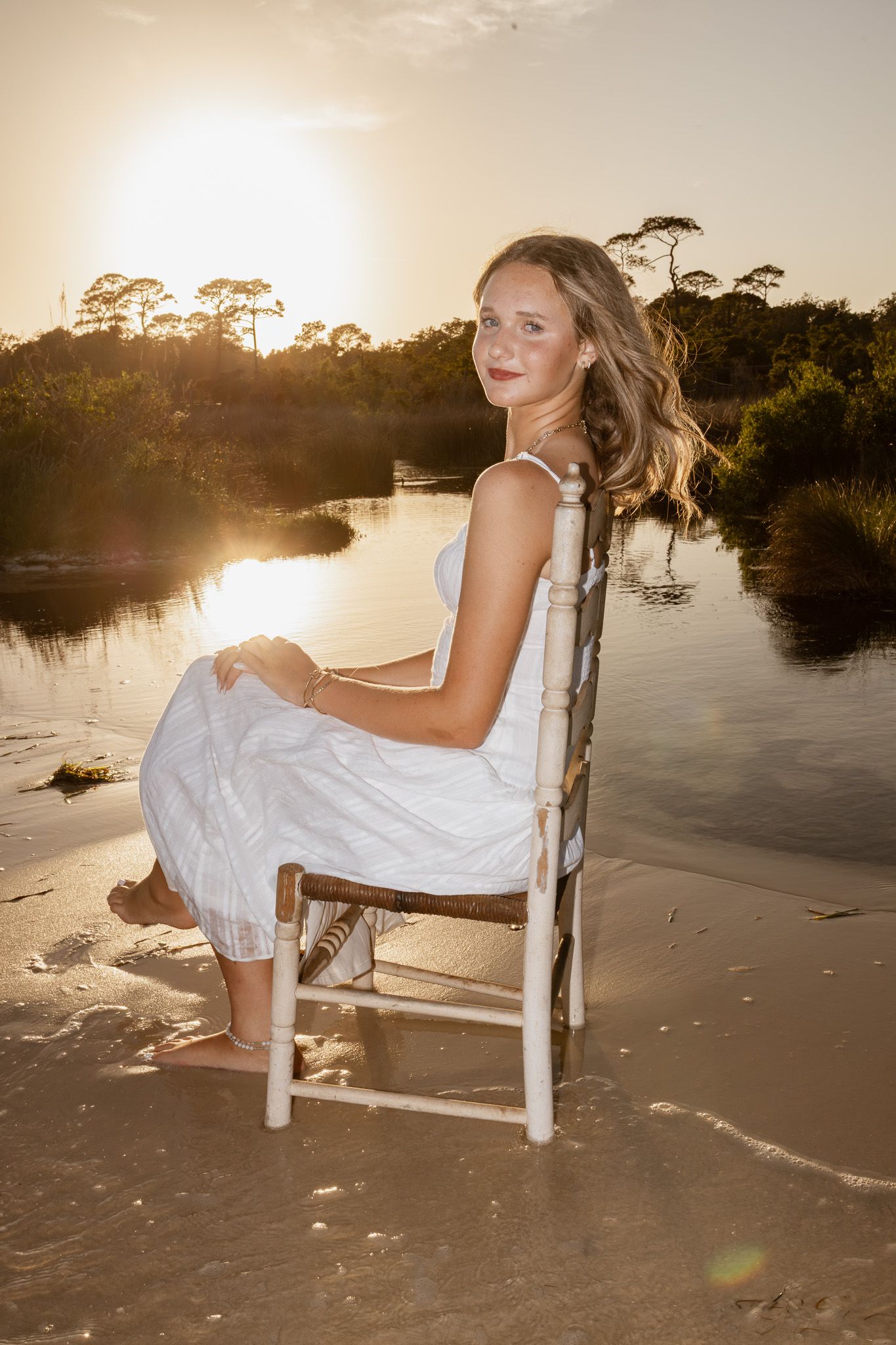 Pensacola Beach senior photography session featuring a graduate posing by the water