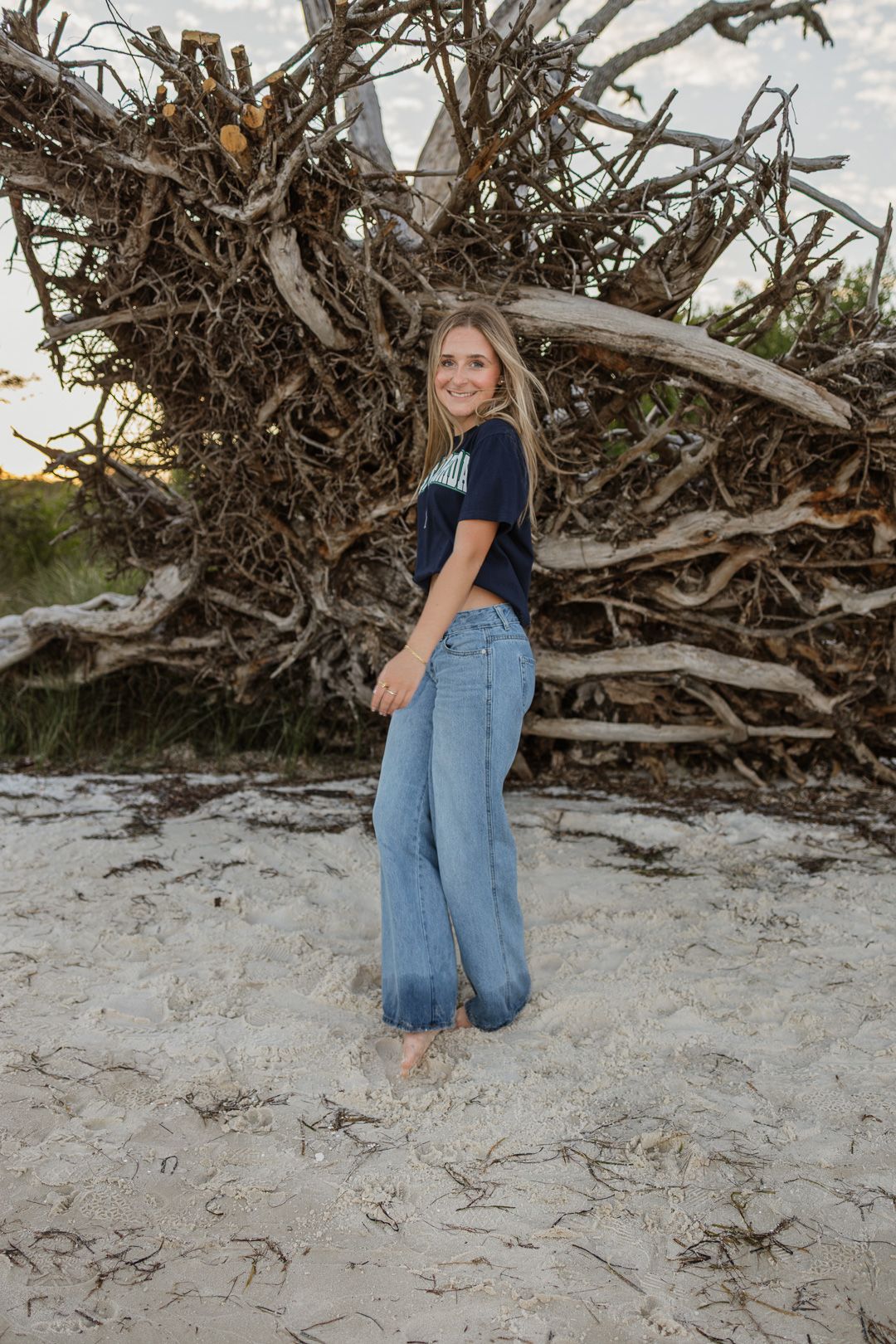 Pensacola Beach senior photography session featuring a graduate posing by the water