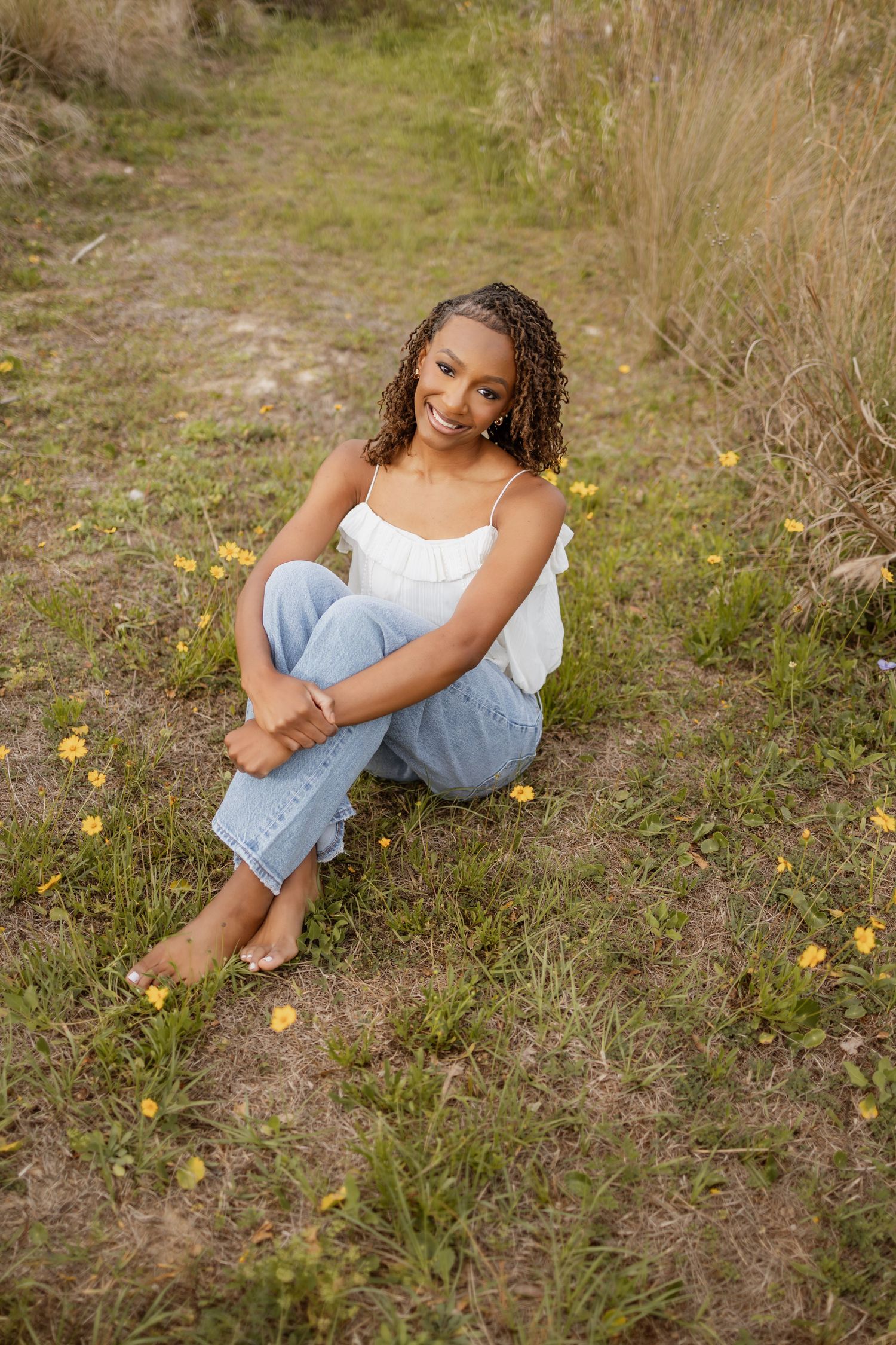 Pensacola Beach senior photography session featuring a graduate posing by the water