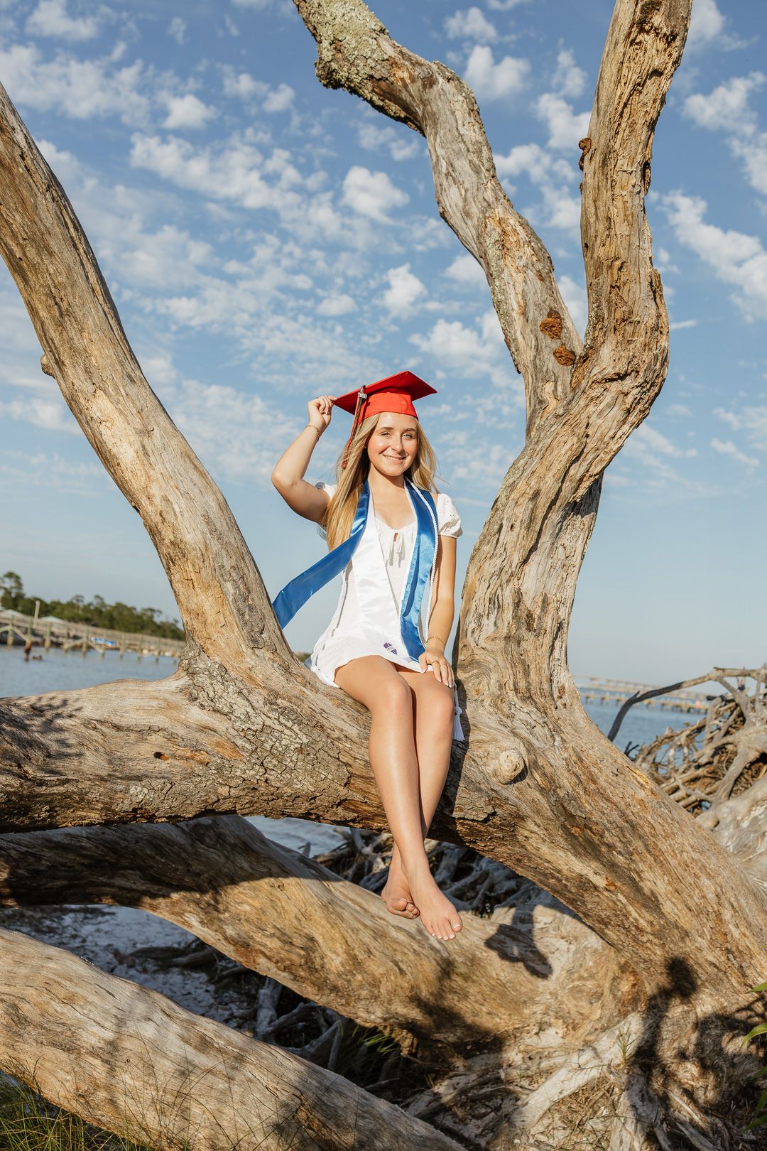 Pensacola Beach senior photography session featuring a graduate posing by the water