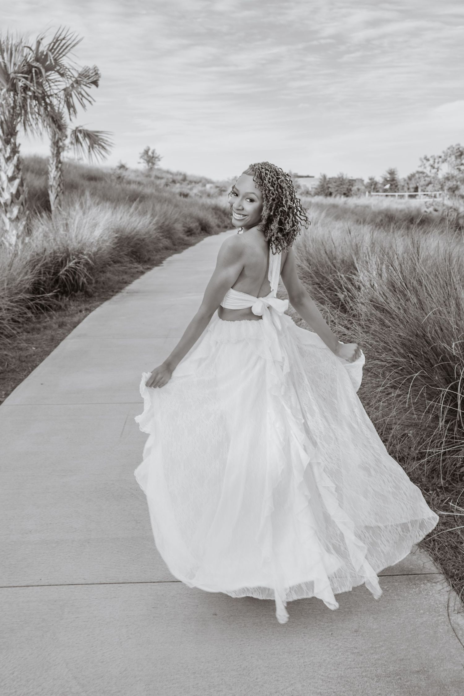 Pensacola Beach senior photography session featuring a graduate posing by the water