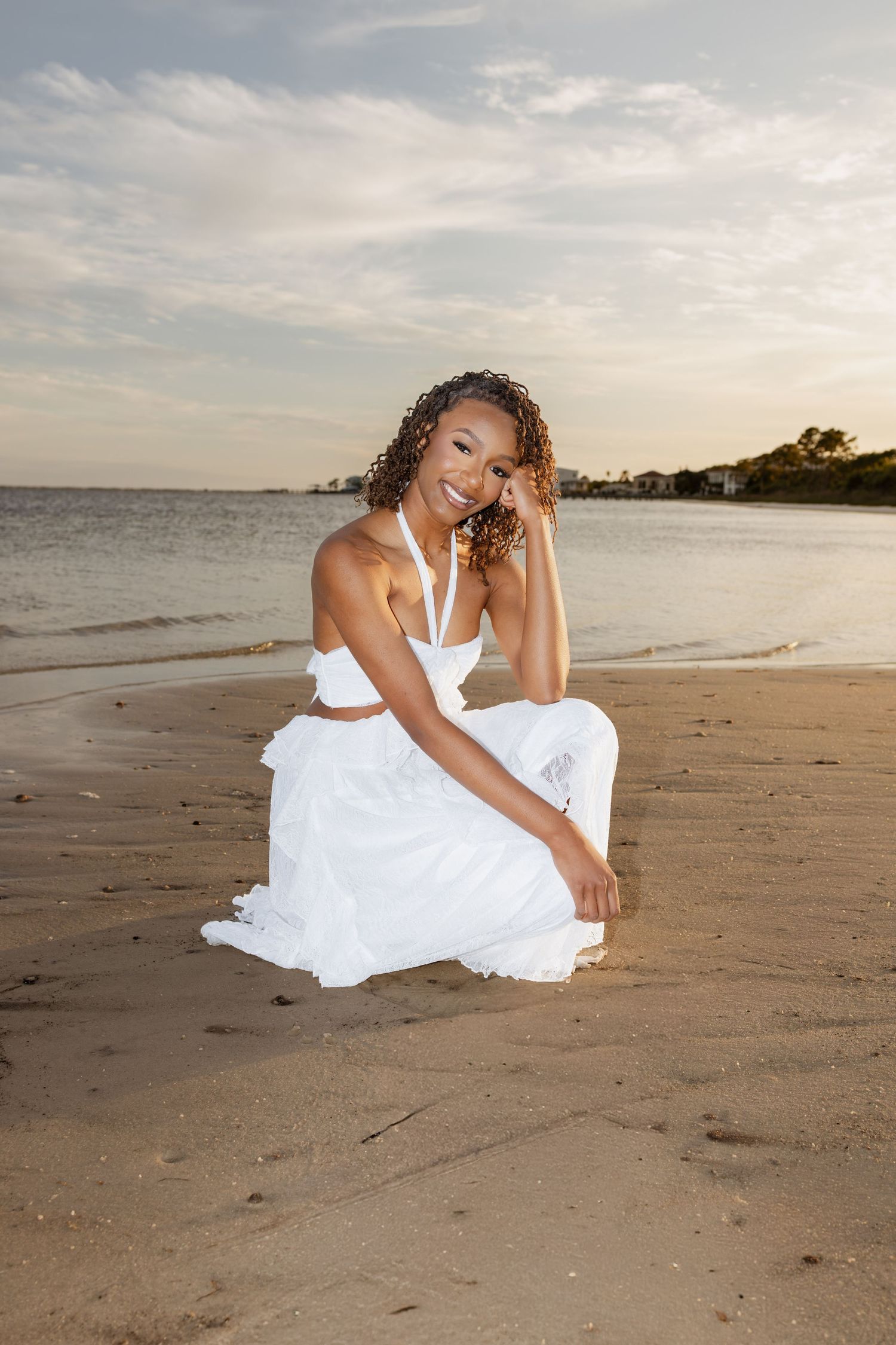 Pensacola Beach senior photography session featuring a graduate posing by the water