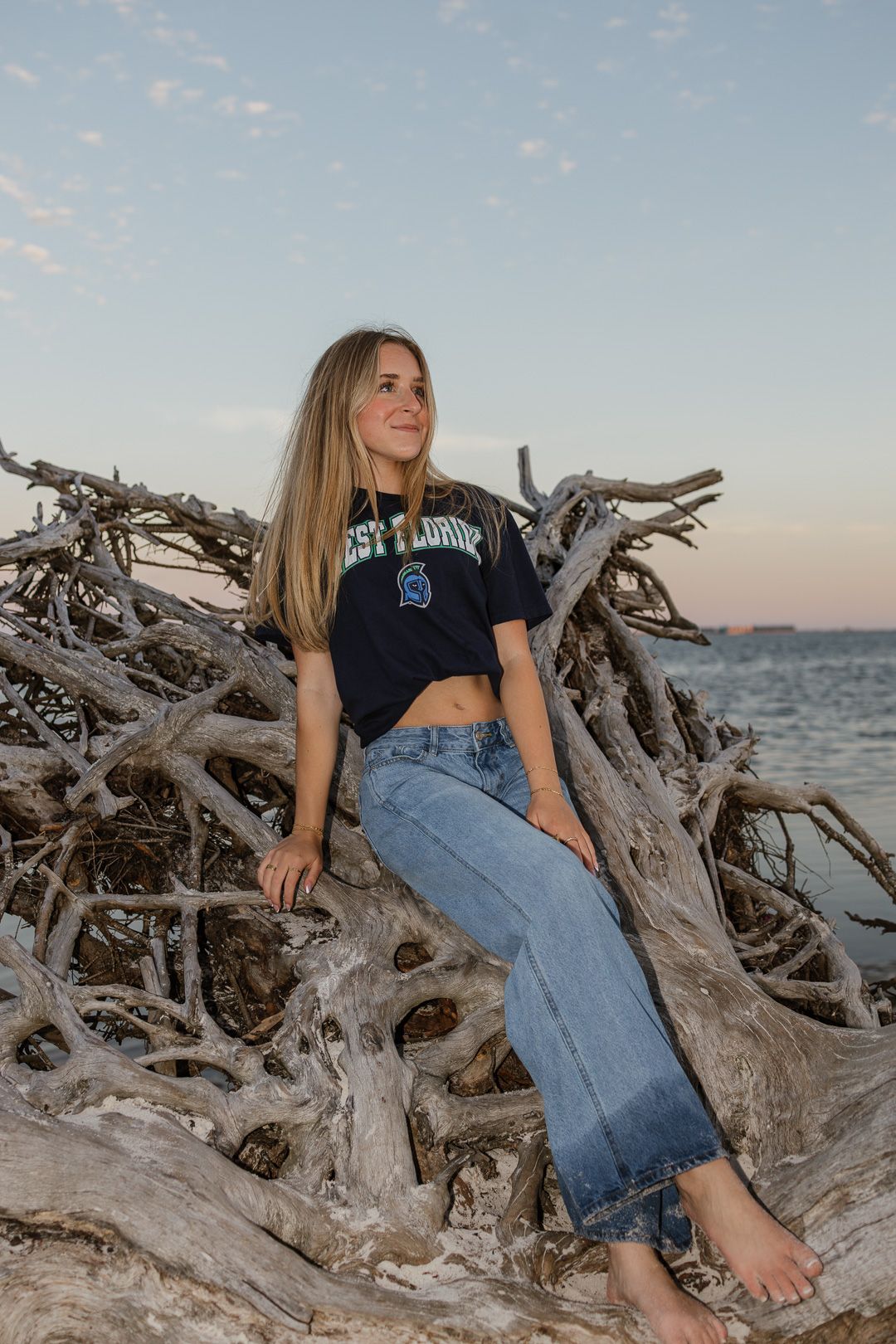 Pensacola Beach senior photography session featuring a graduate posing by the water
