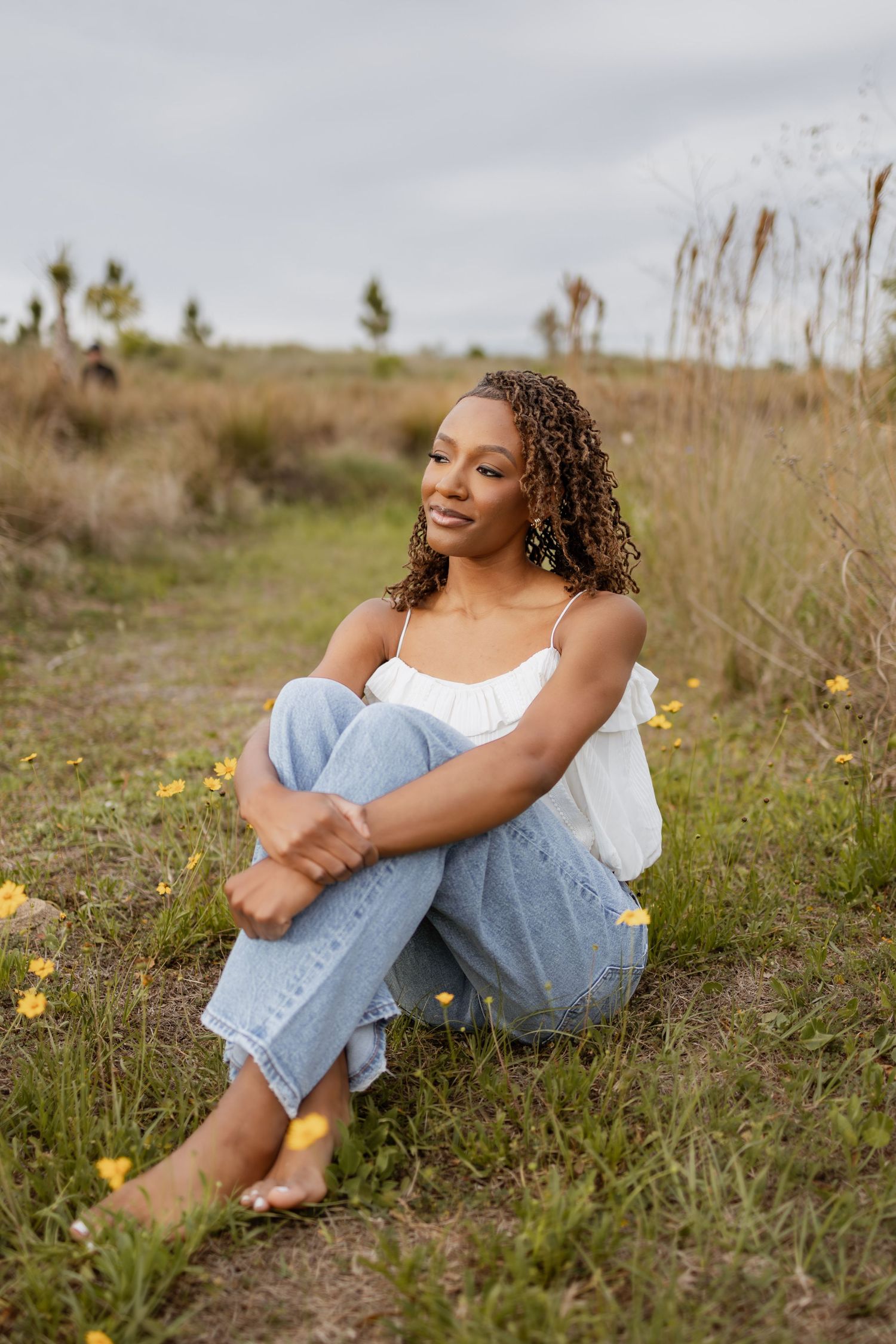 Pensacola Beach senior photography session featuring a graduate posing by the water