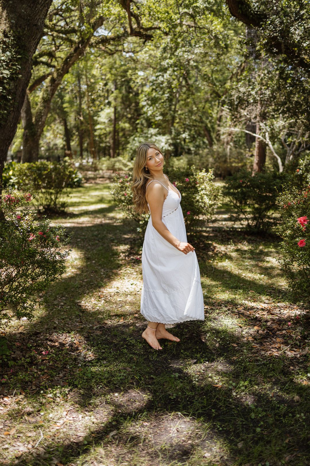 High school senior posing beneath oak trees at Eden Gardens State Park in Santa Rosa Beach Florida.