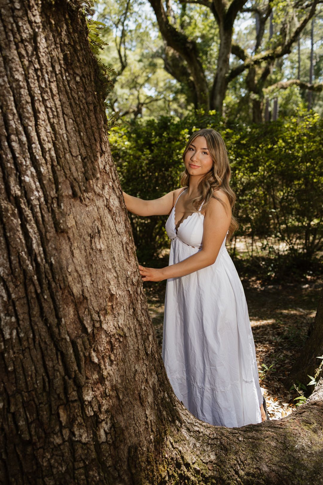 High school senior posing beneath oak trees at Eden Gardens State Park in Santa Rosa Beach Florida.