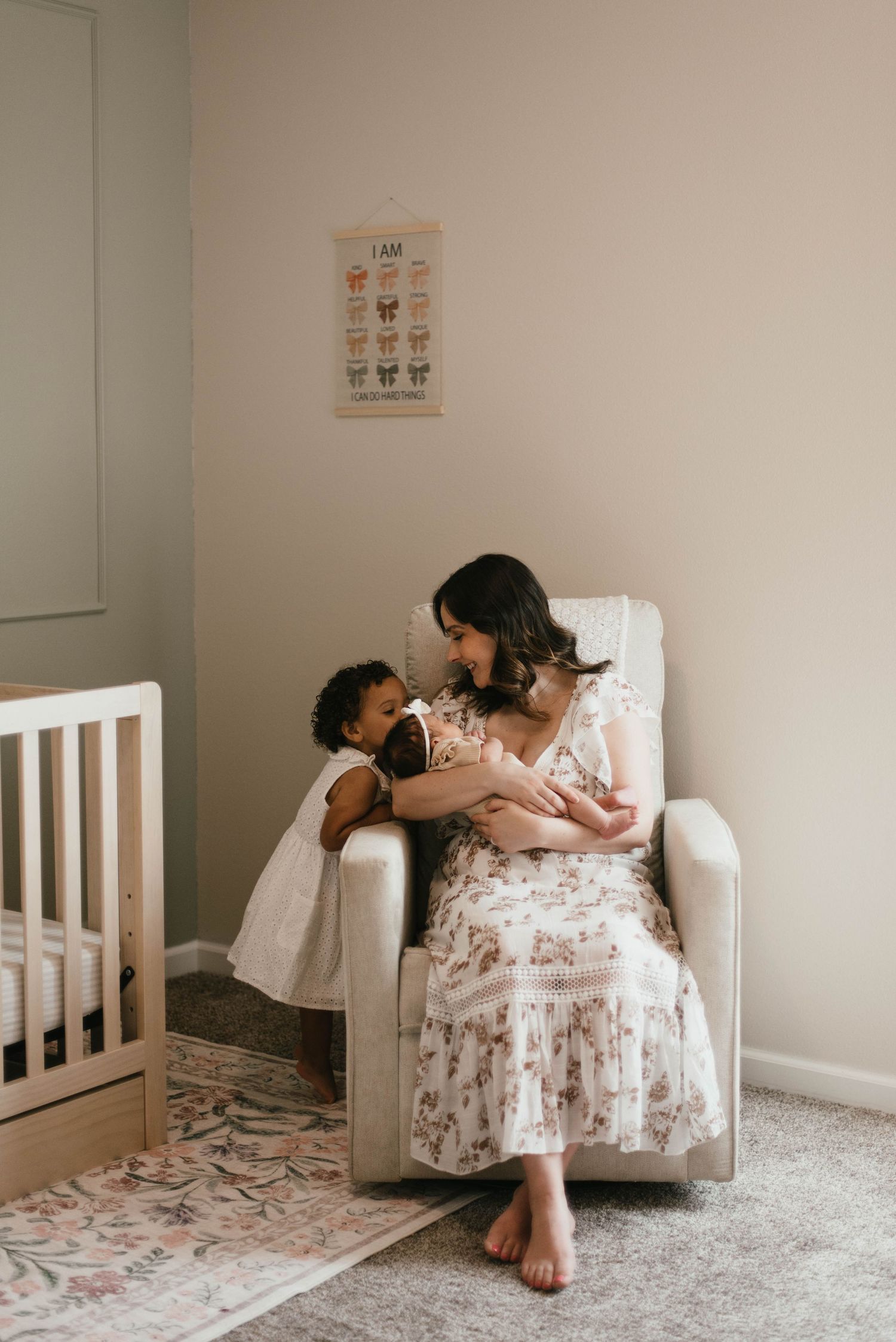 Intimate family moment captured in nursery with white crib and floral decor.
