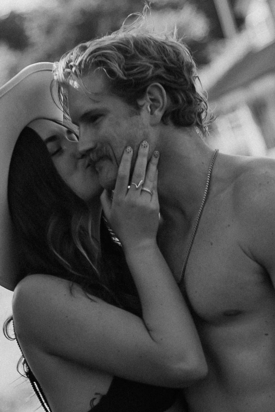 Romantic black and white close-up portrait of an intimate couple moment.