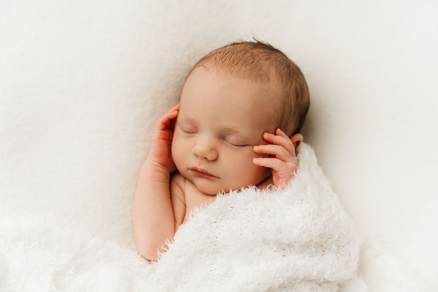 een foto van een slapende baby in een tijdloze setting tijdens een newborn reportage in studio in zandhoven