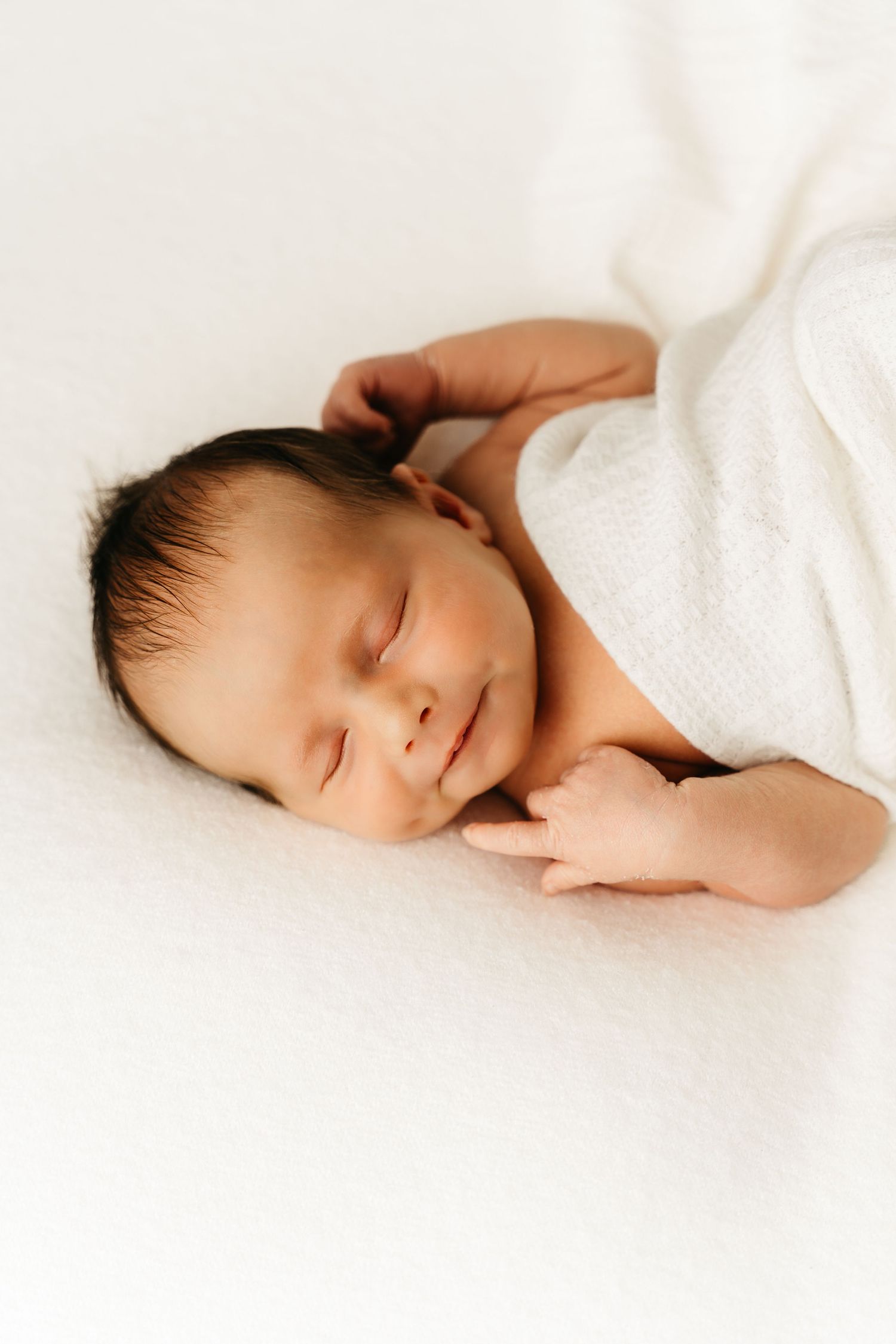 een foto van een slapende baby in een tijdloze setting tijdens een newborn reportage in studio in zandhoven