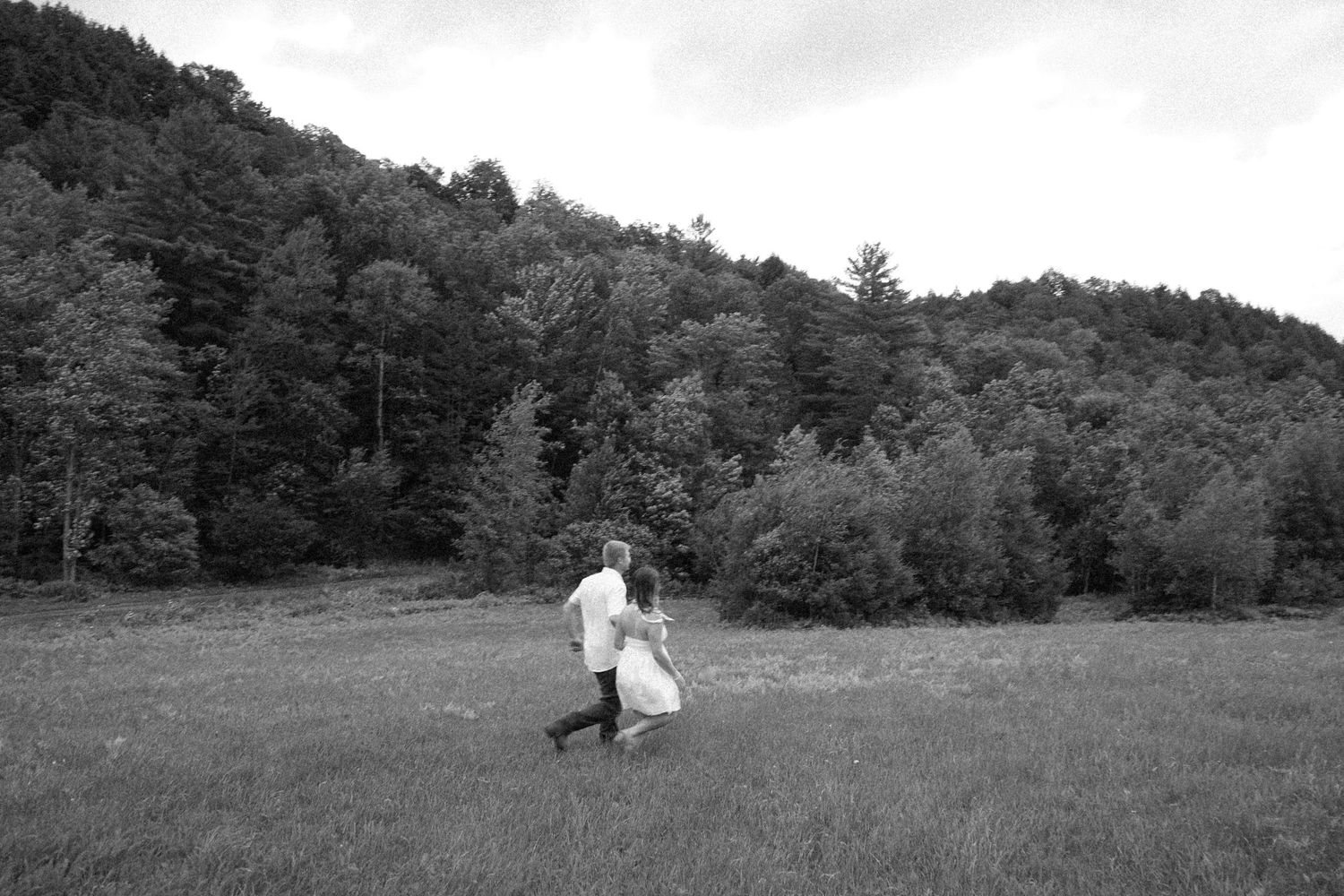 black and white image of couple in field