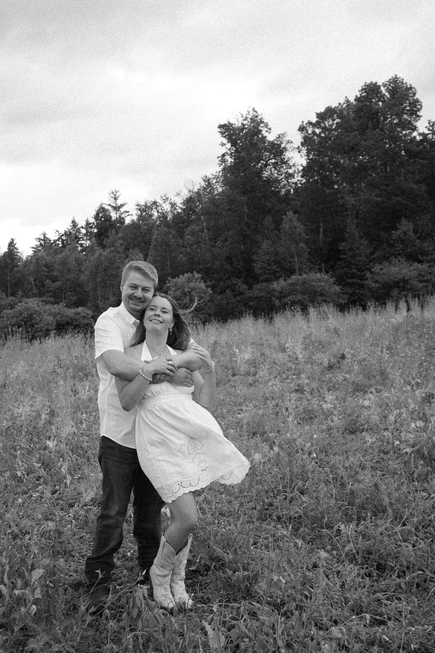 black and white image of couple in field