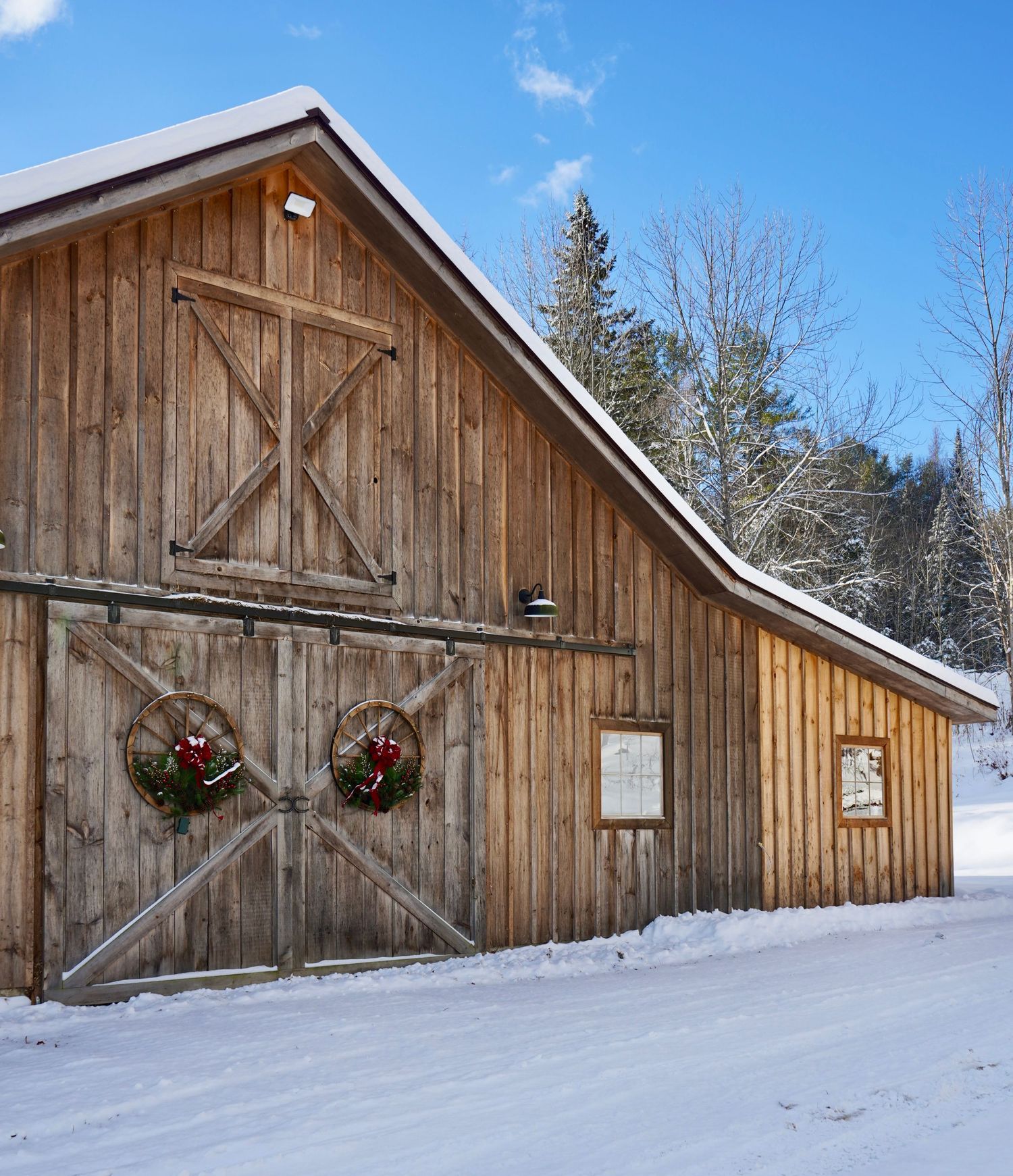 Front of barn with wreaths hanging on doors