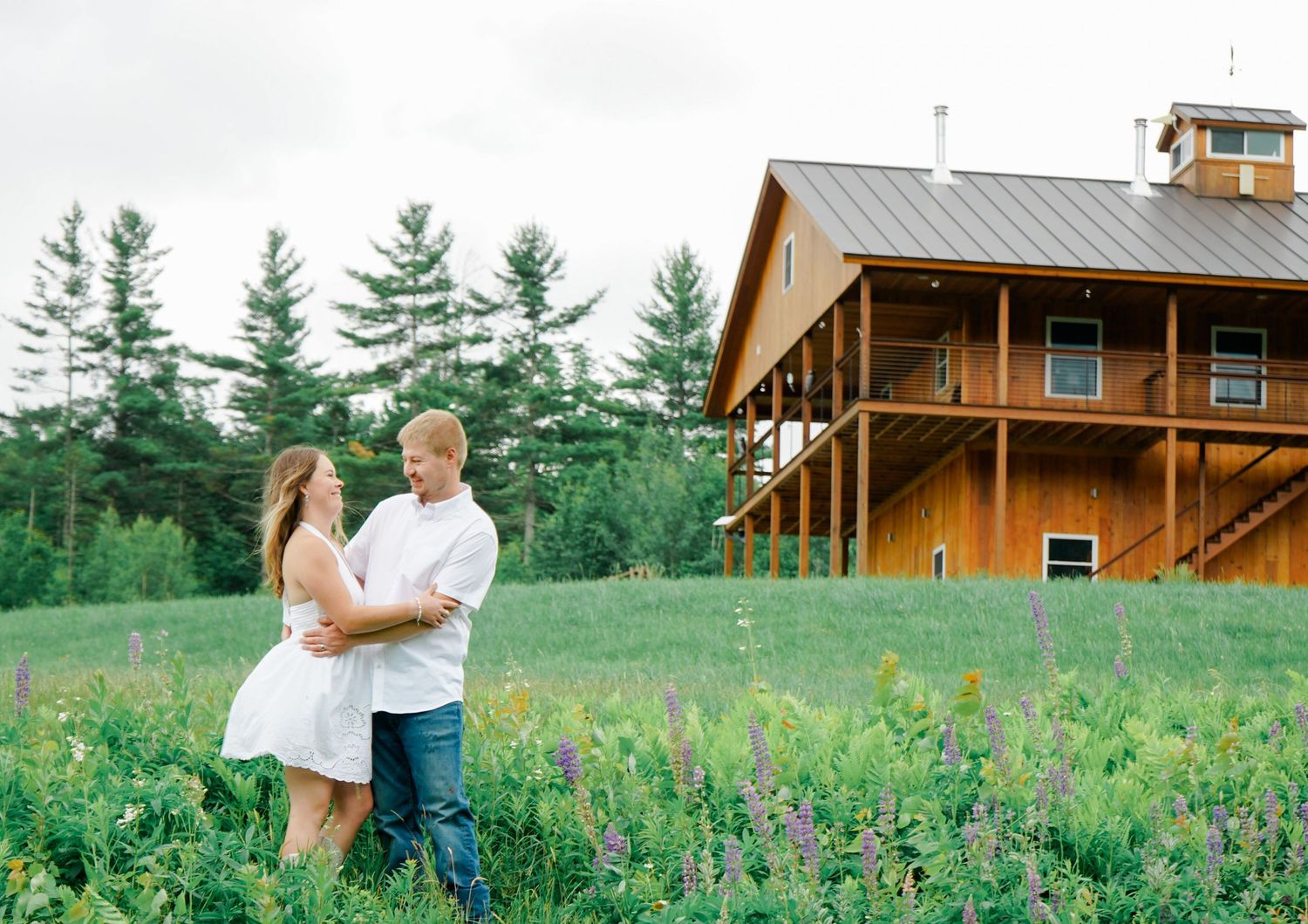 image of couple in field with cabin in the background