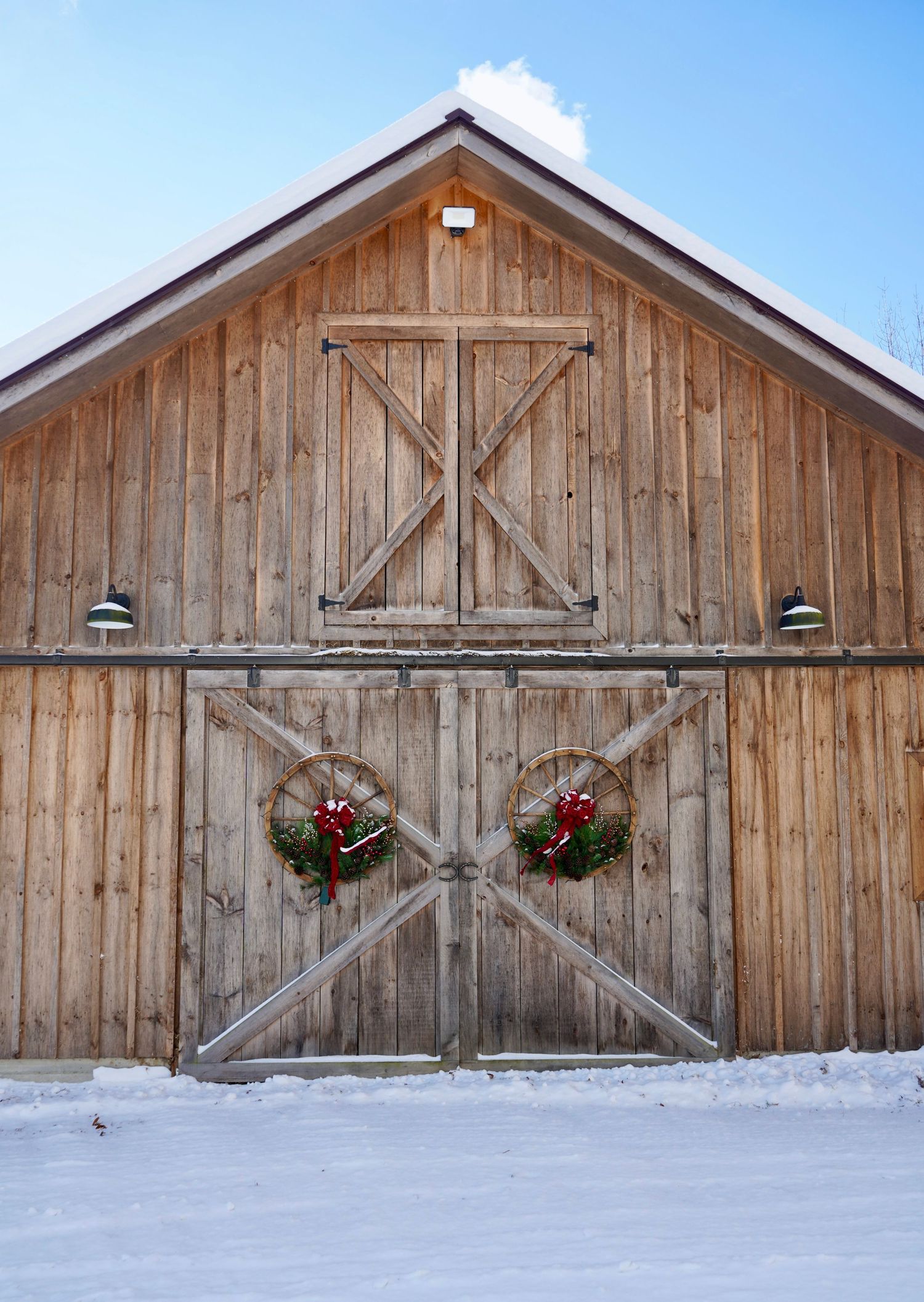 Front of barn with wreaths hanging on doors