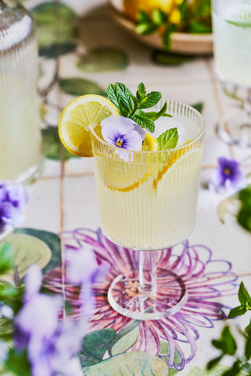 Lemon and mint lemonade on floral surface