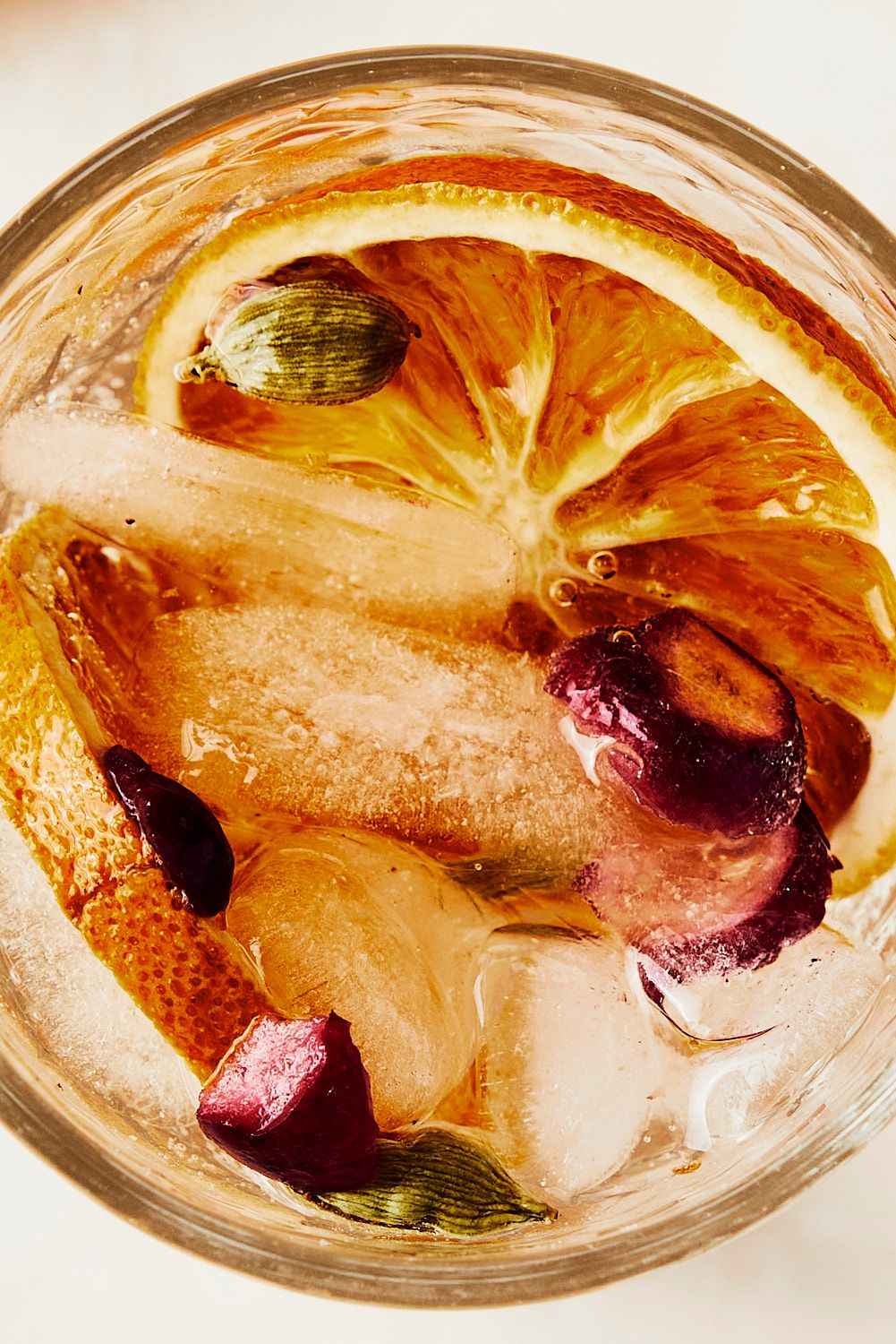 Macro shot of drink garnish of orange slices and herbs