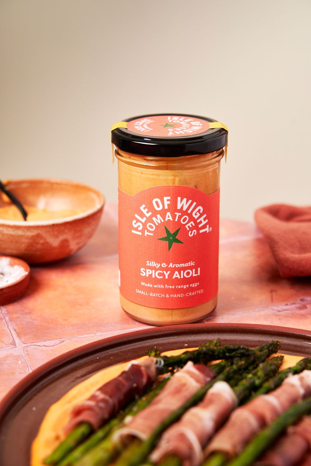 Product shot of tomato aioli with asparagus