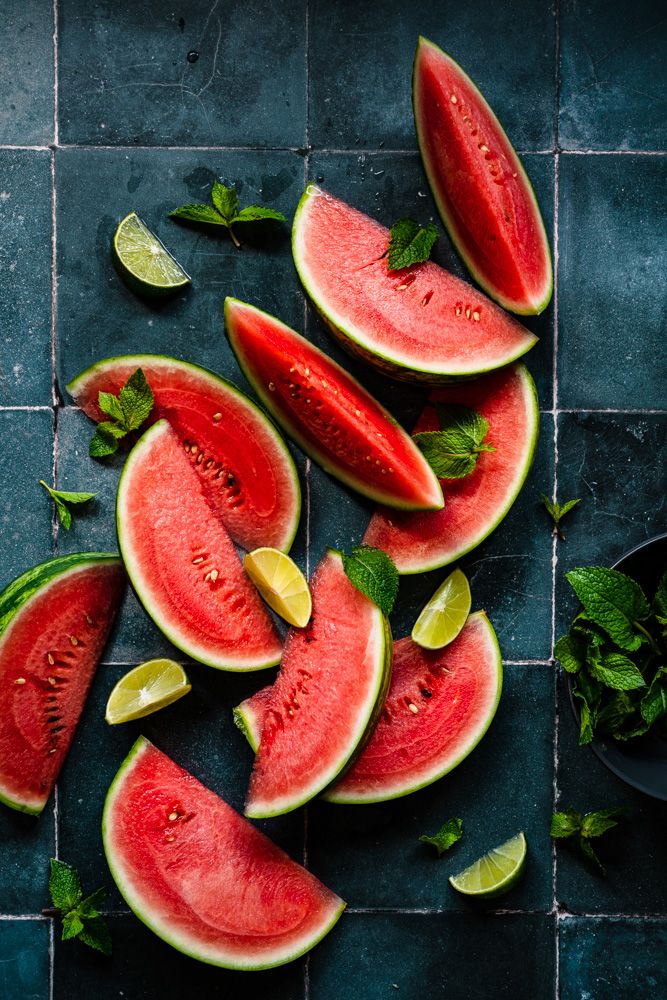 Flatlay of watermelon slices on blue tiles