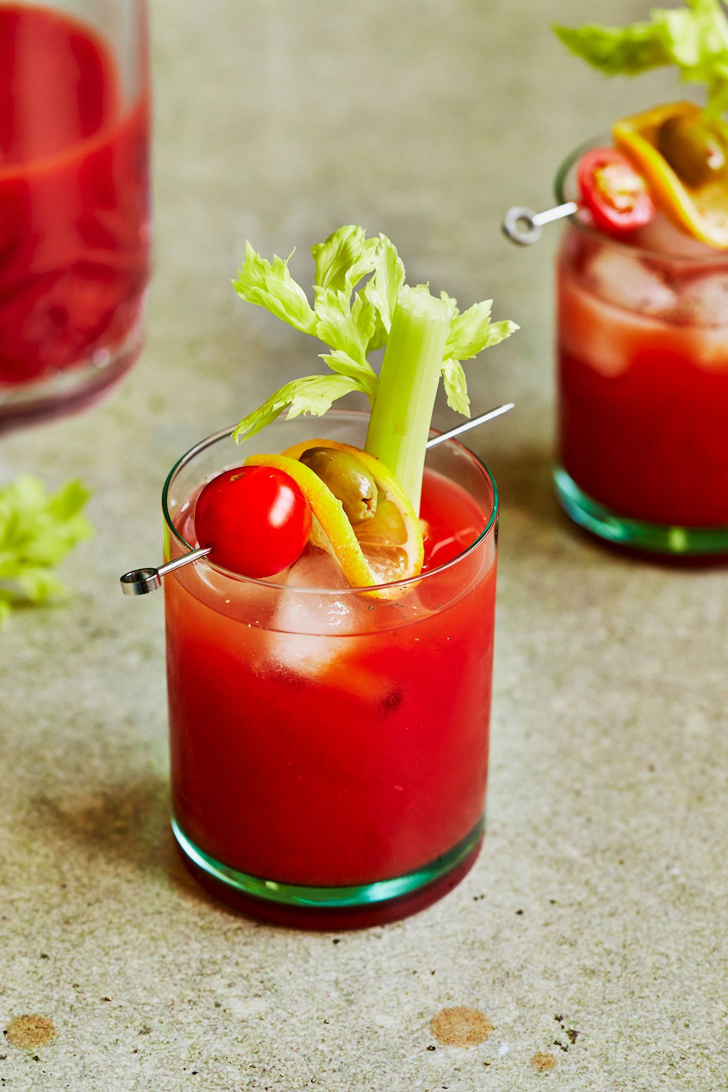 Bloody mary cocktail on green surface