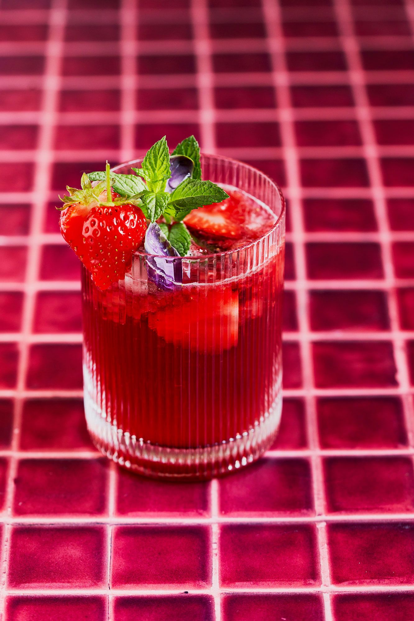 Strawberry basil spritz cocktail on red tiles