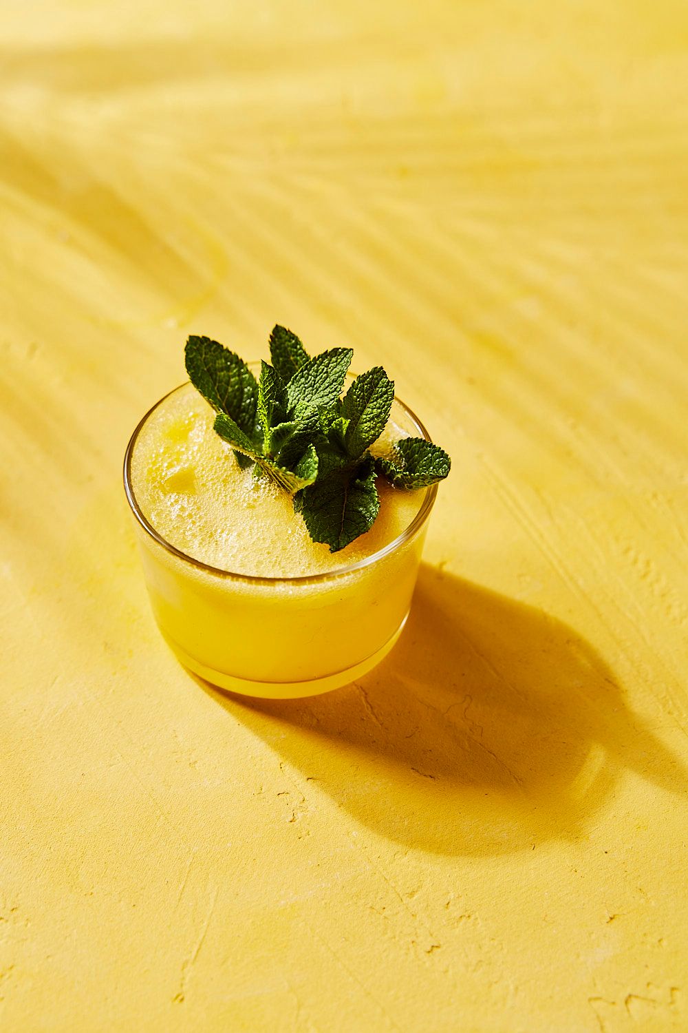 Pineapple G&T cocktail on yellow background
