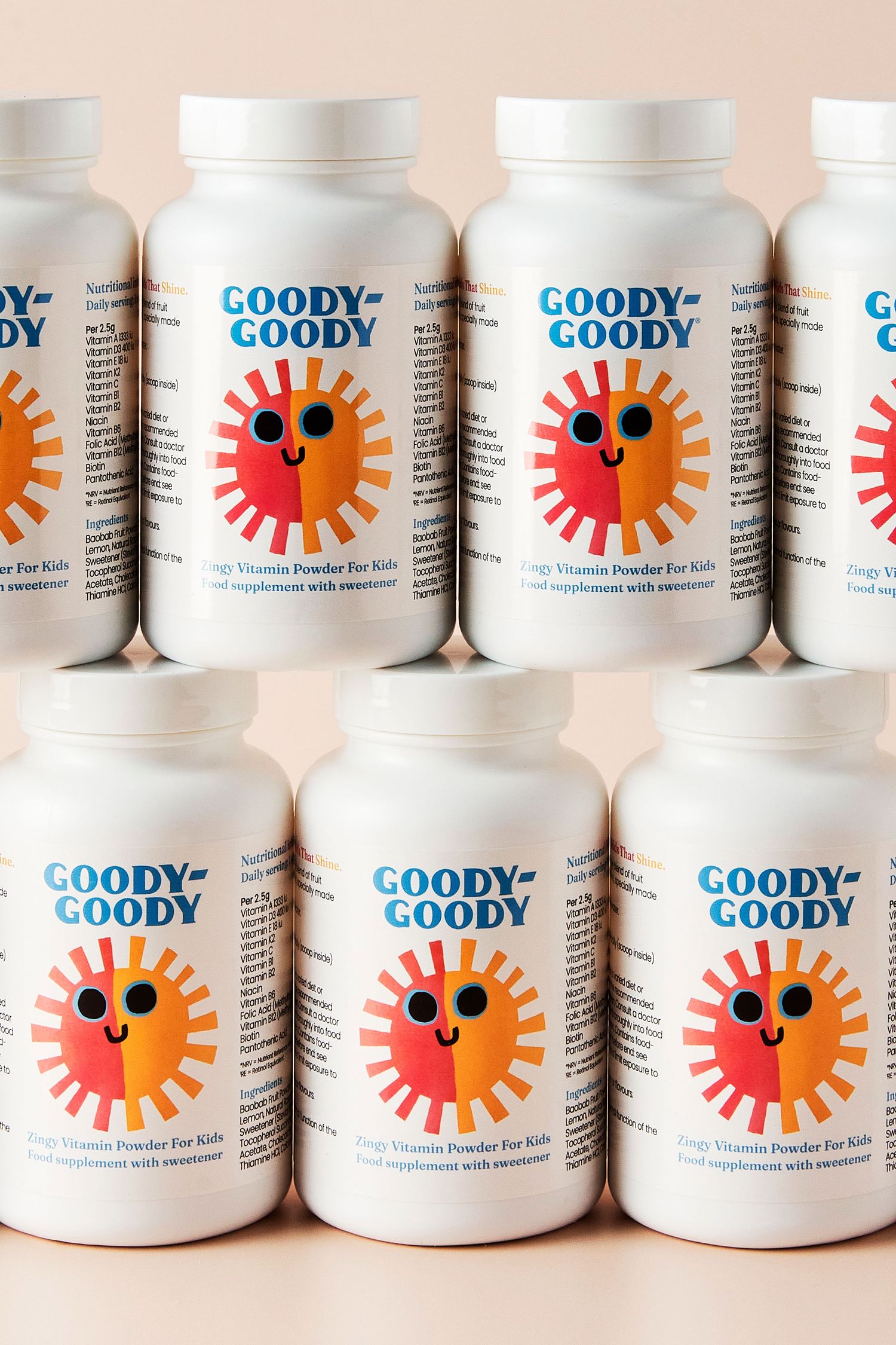 Six bottles of vitamin powder arranged in rows on a pink background.