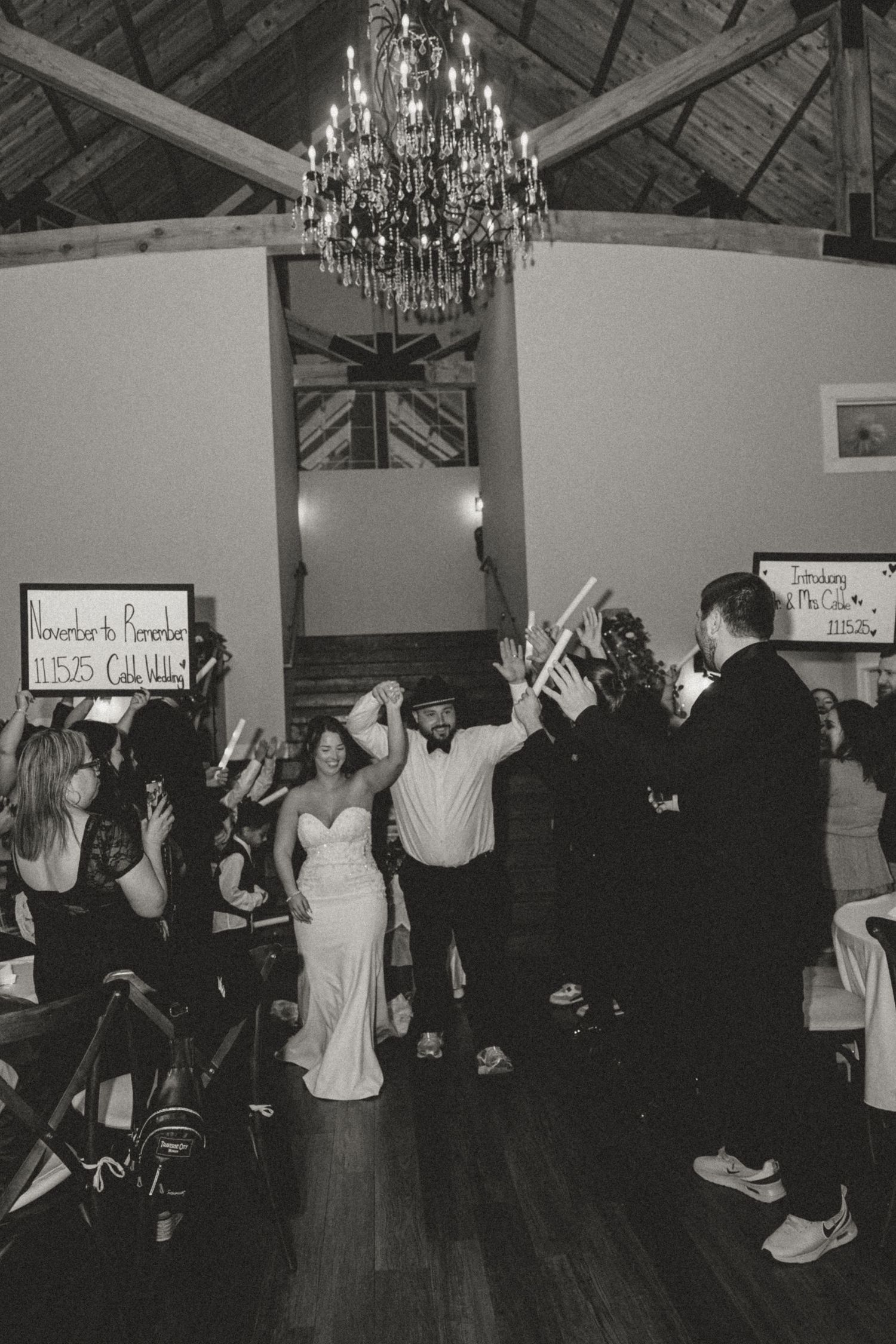 A black and white photo series showing people dancing in a room with chandeliers and hardwood floors.