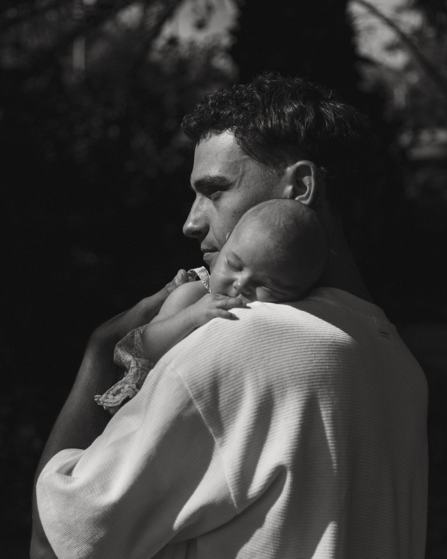 Black and white intimate portraits showing tender moments between two people.
