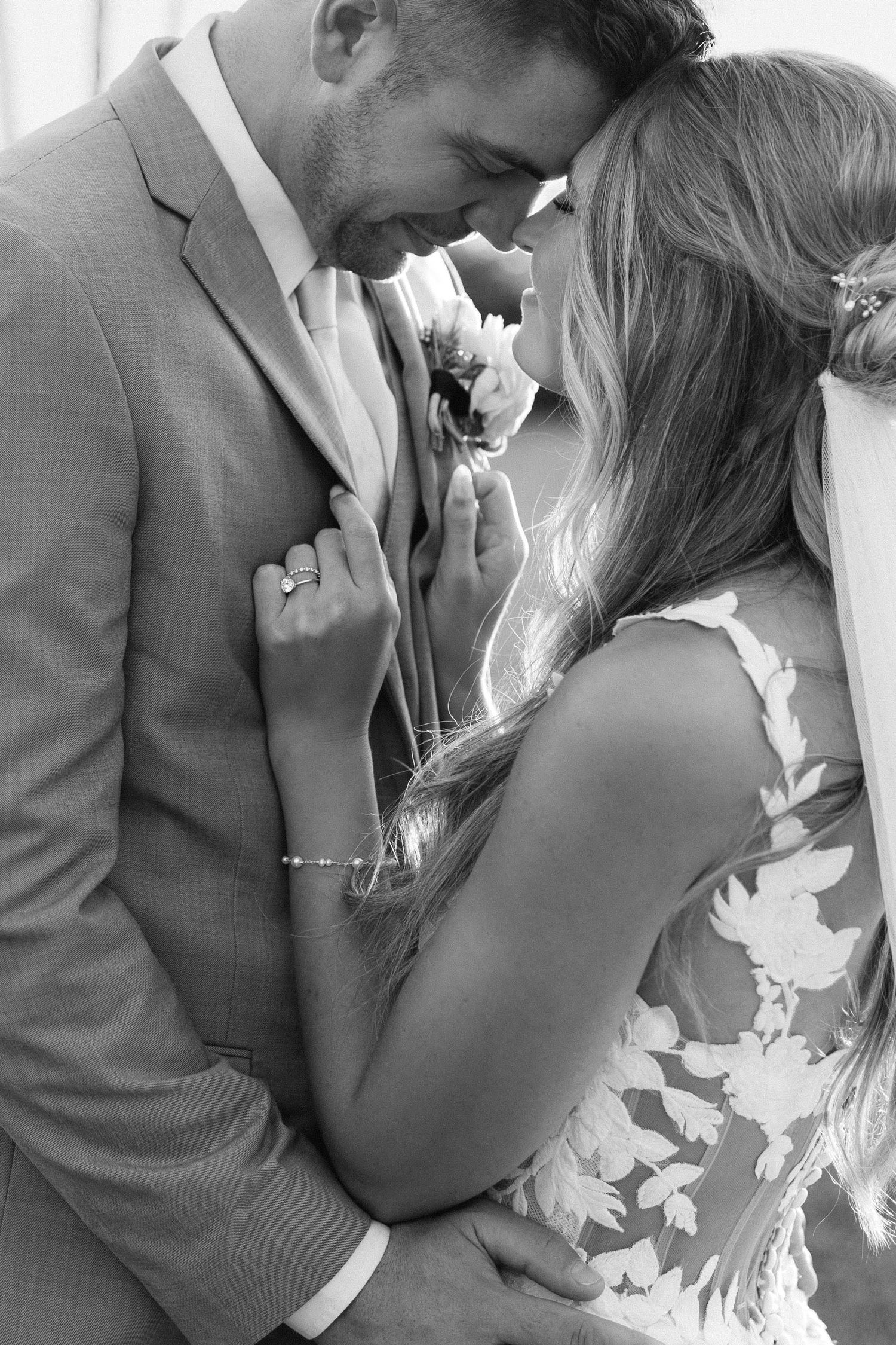 Romantic black and white wedding photo series showing intimate moments between newlyweds.