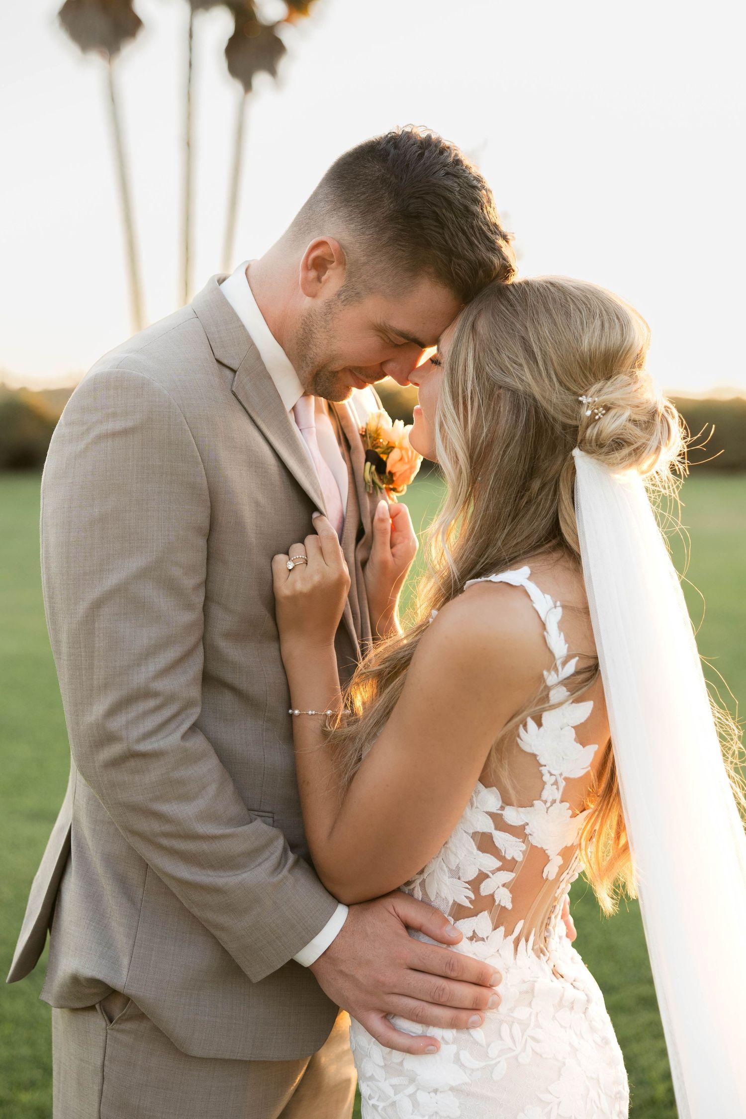 Romantic sunset moment captured during an outdoor wedding ceremony.