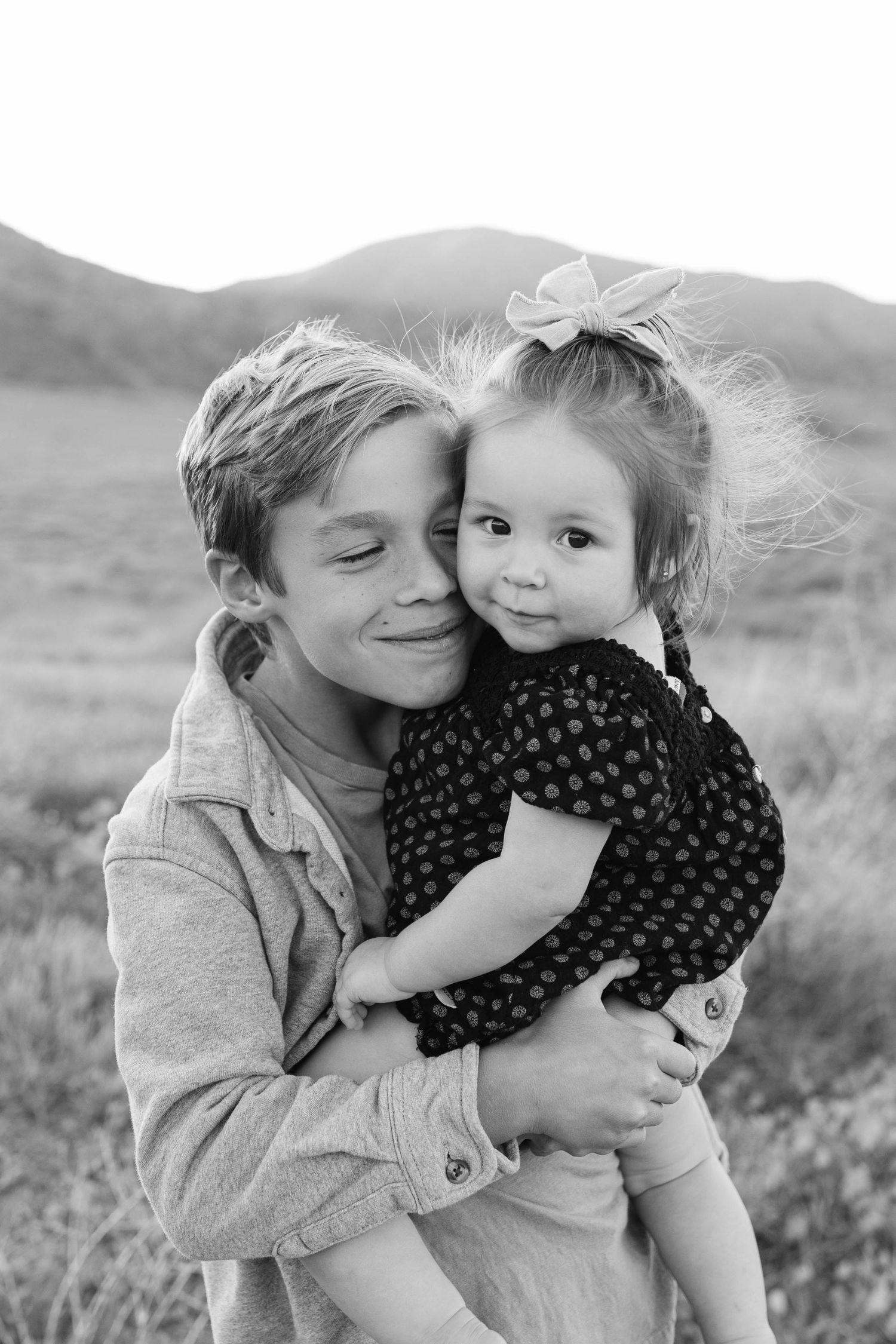 Sweet candid moment between parent and child in a natural outdoor setting.