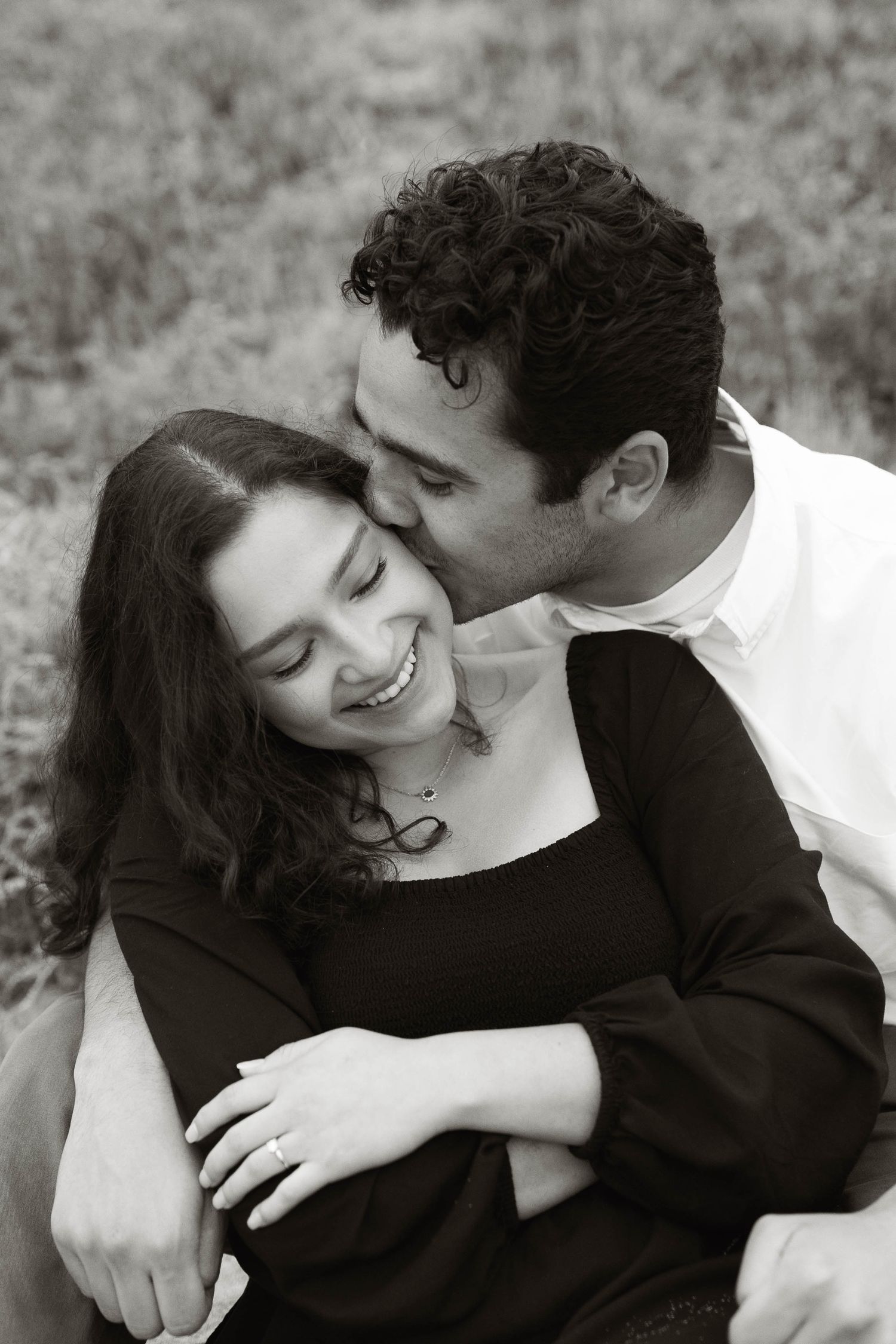 An intimate black and white portrait series of a couple embracing.