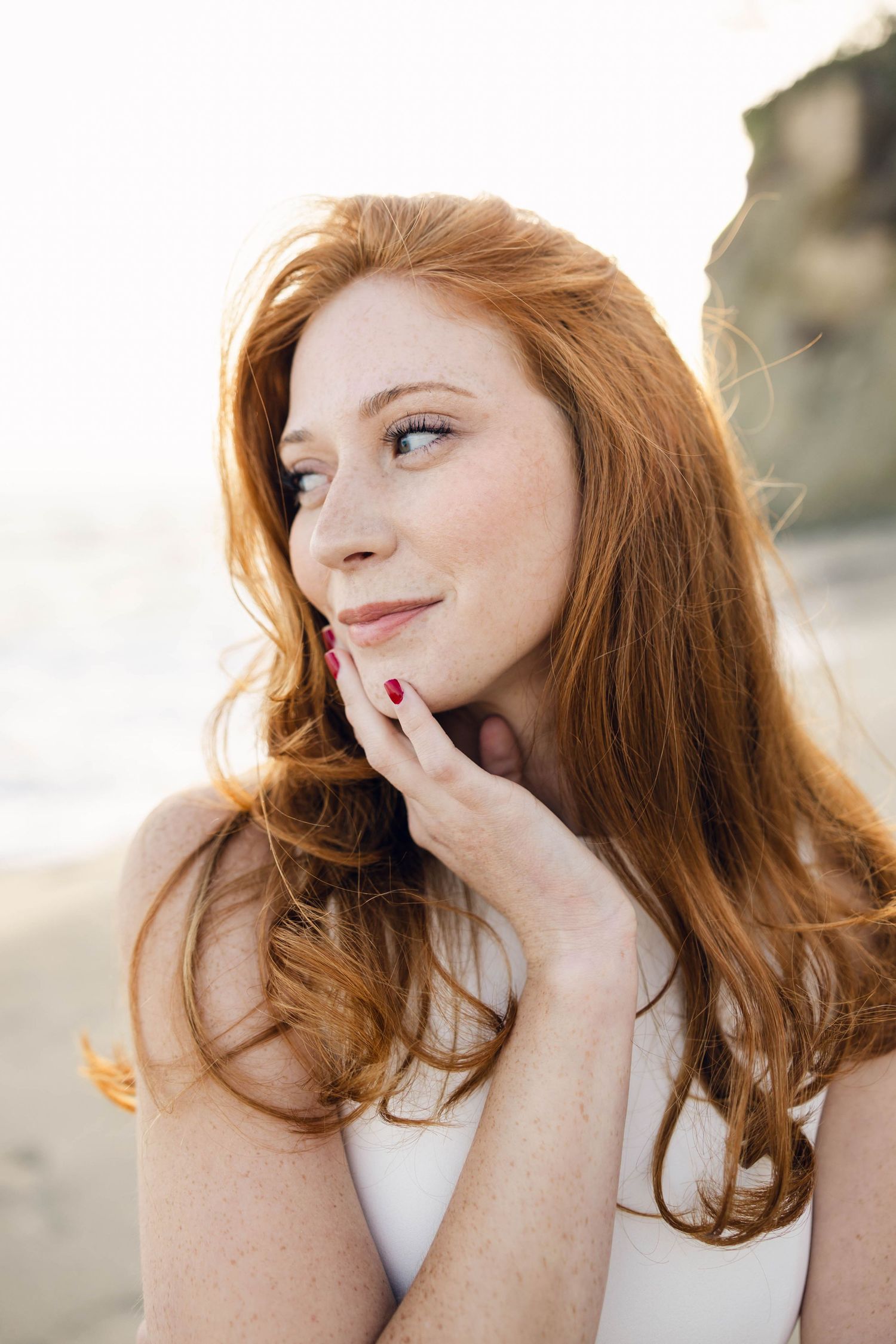 Portrait series showing natural expressions against bright outdoor background.