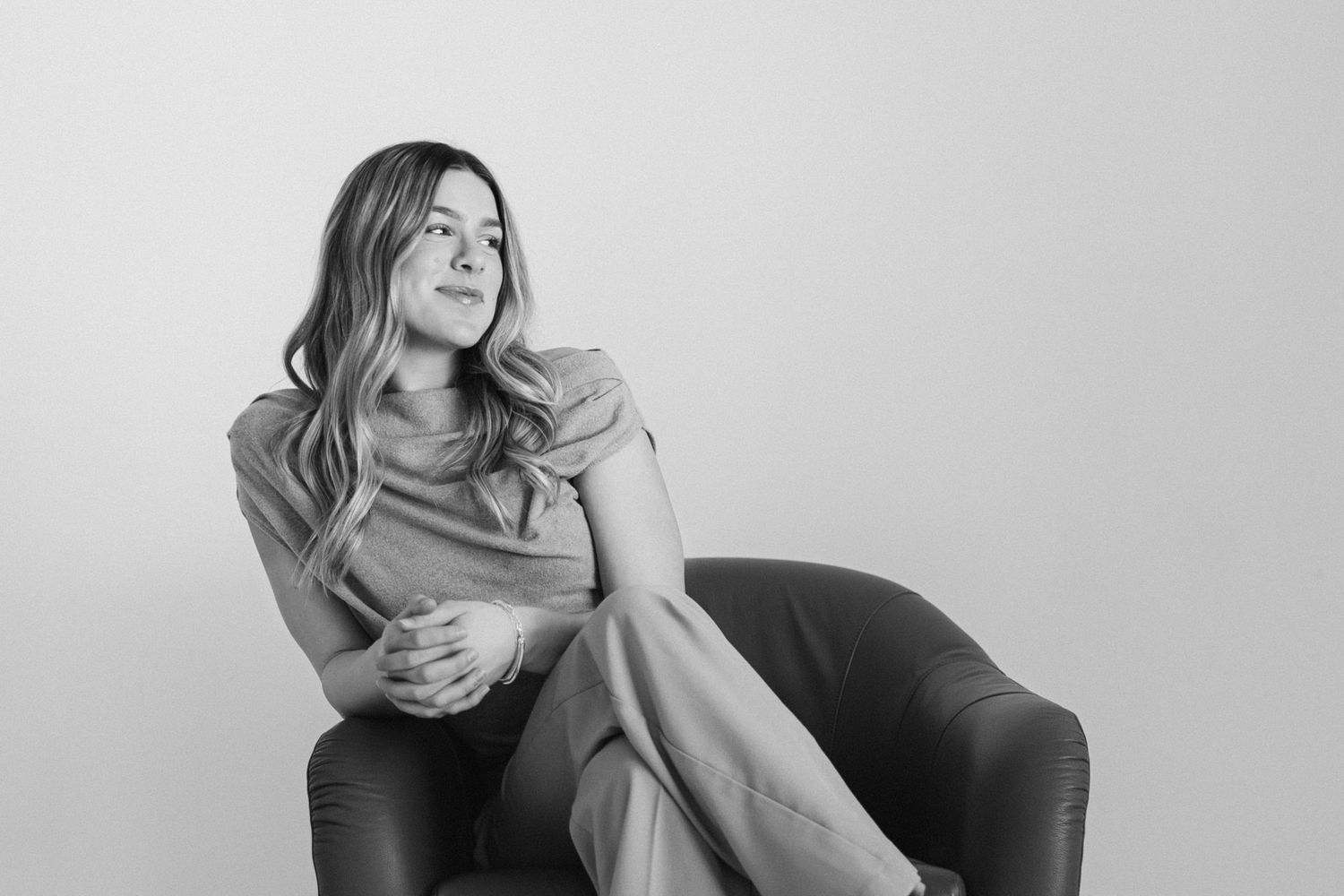 Professional portrait session on leather chair showing relaxed candid moments.