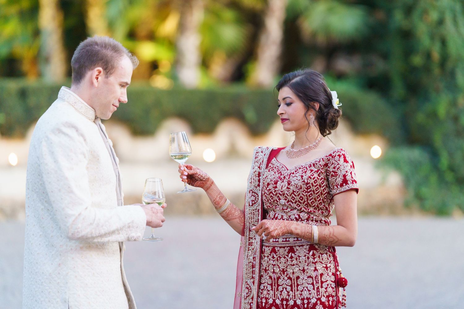 Candid moment of two people sharing drinks at an outdoor celebration.