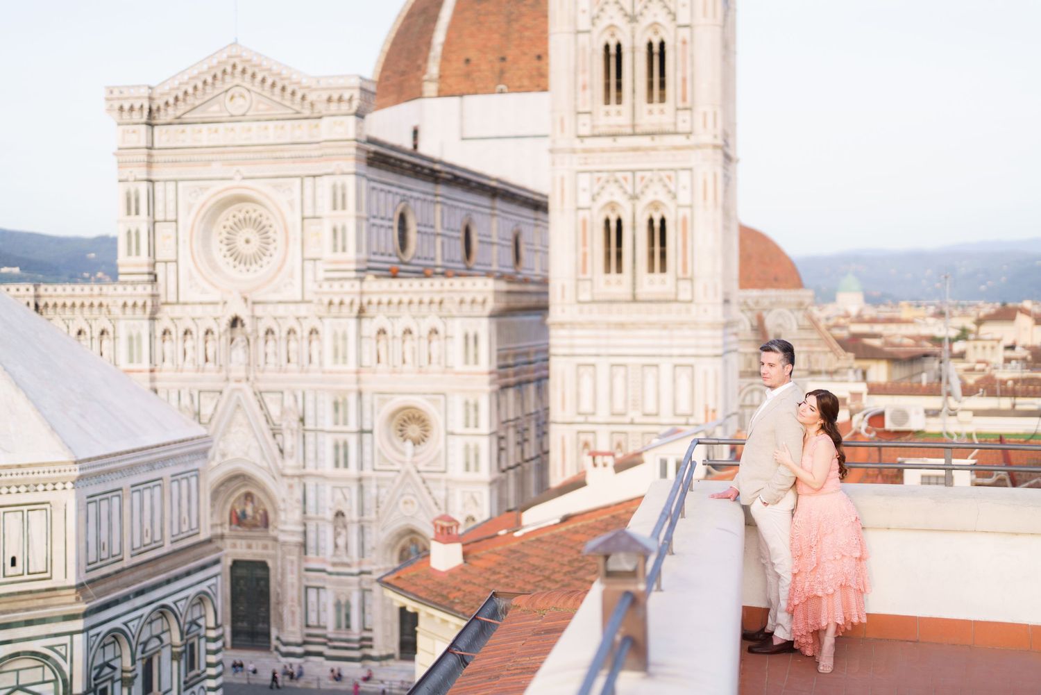 Scenic view of Florence Cathedral's iconic dome and architecture from a rooftop terrace in Italy.