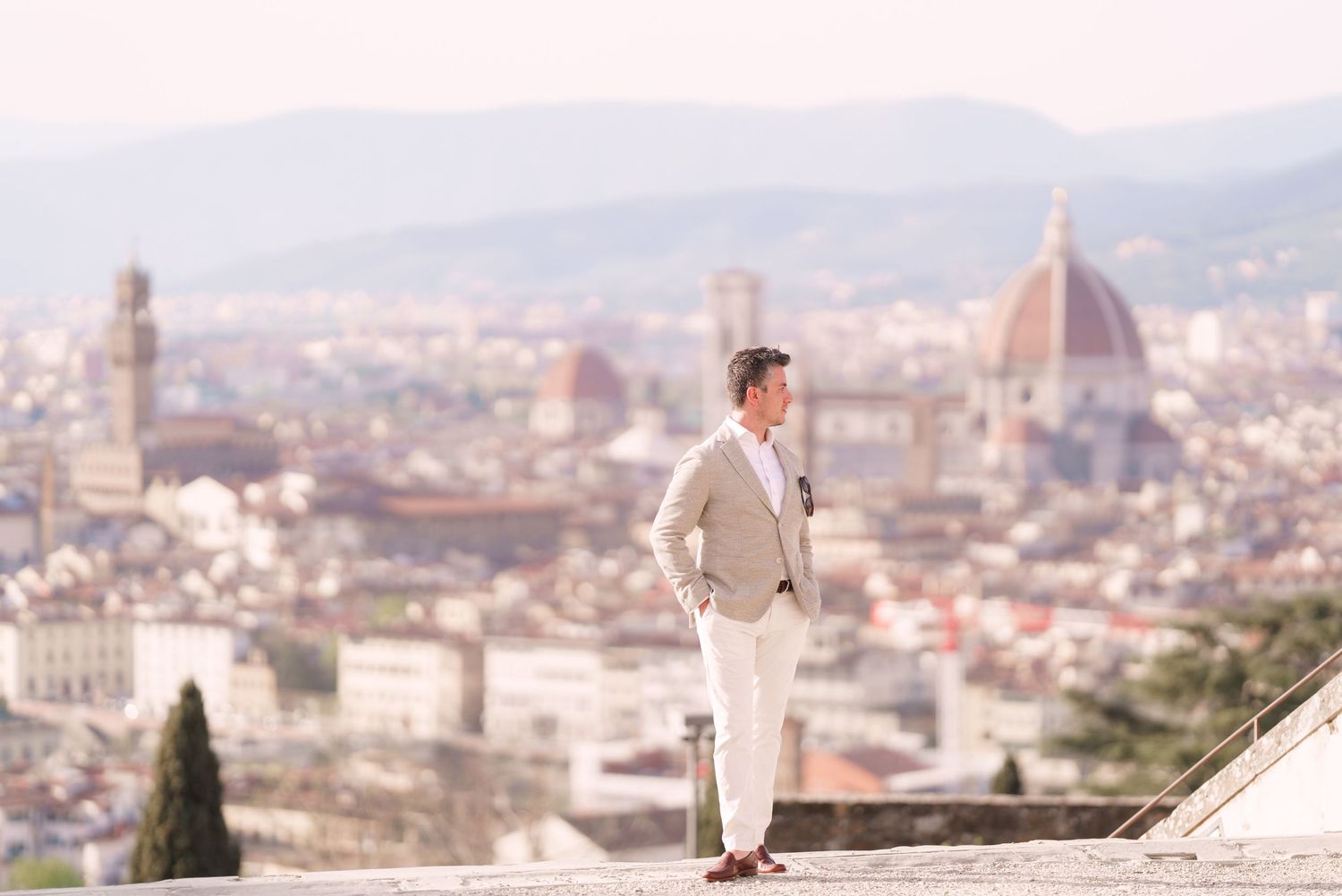 A scenic panoramic view of Florence, Italy with the iconic Duomo cathedral dome visible in the cityscape.