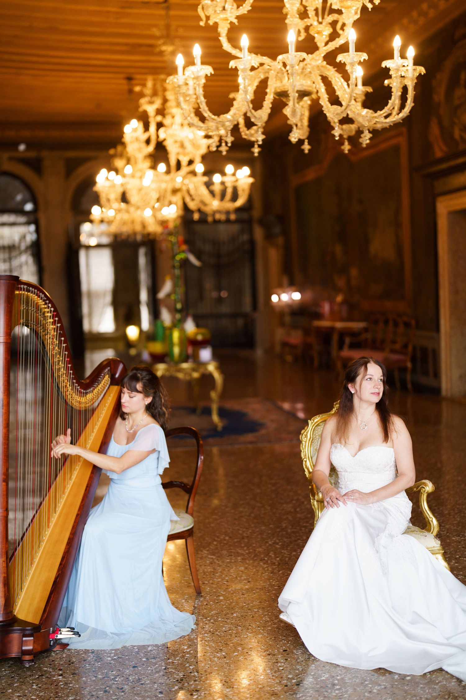 A series of photos showing a harpist in a flowing white dress performing in an elegant ballroom with golden chandeliers.