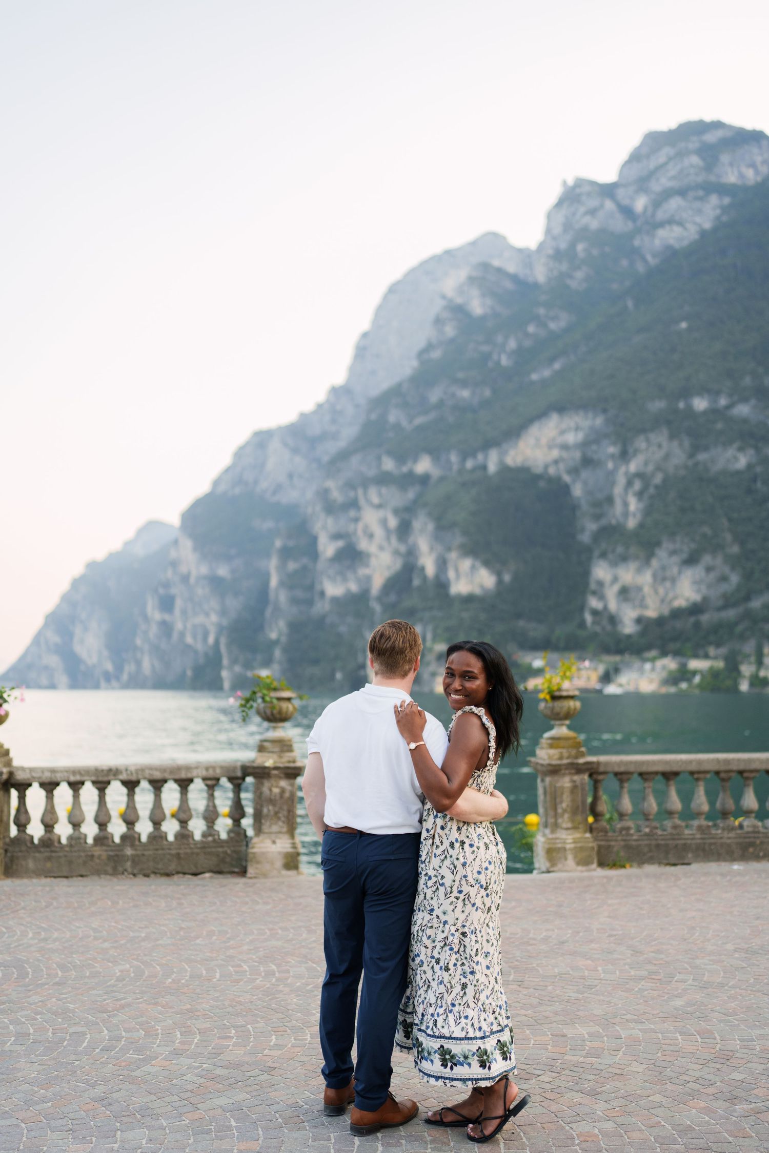 Couple portrait by Lake Garda surrounded by mountains in Riva del Garda, Italy