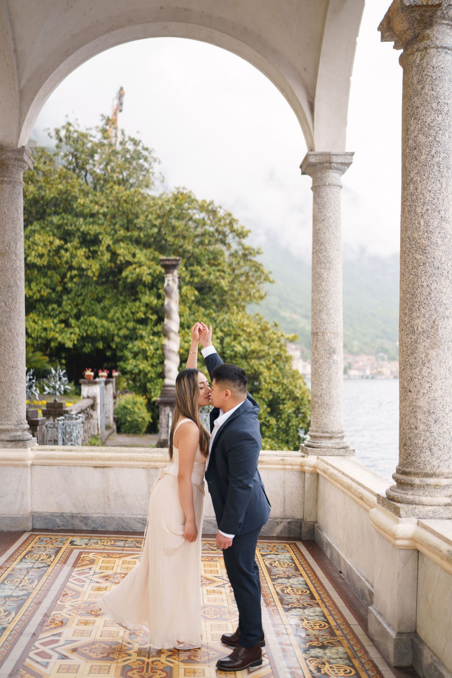 Lake Como proposal photographer capturing surprise engagement at Villa Monastero in Varenna