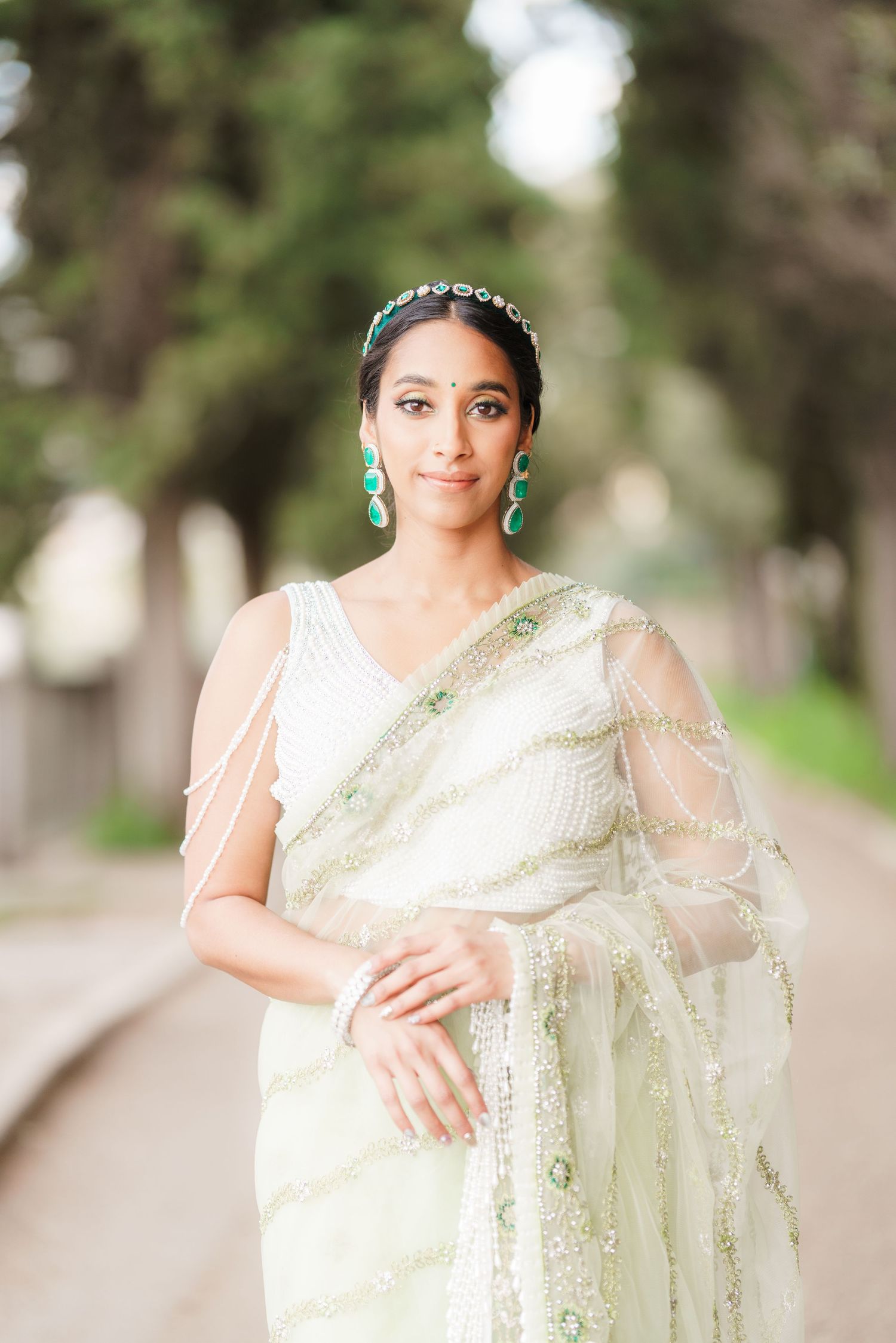 A series of elegant bridal portraits showing a woman in a cream-colored sari against a soft outdoor background.