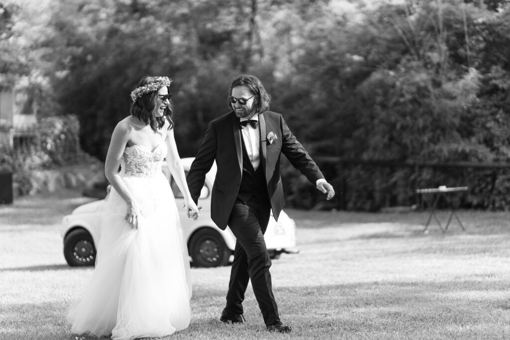 Black and white wedding photography capturing candid moments outdoors.